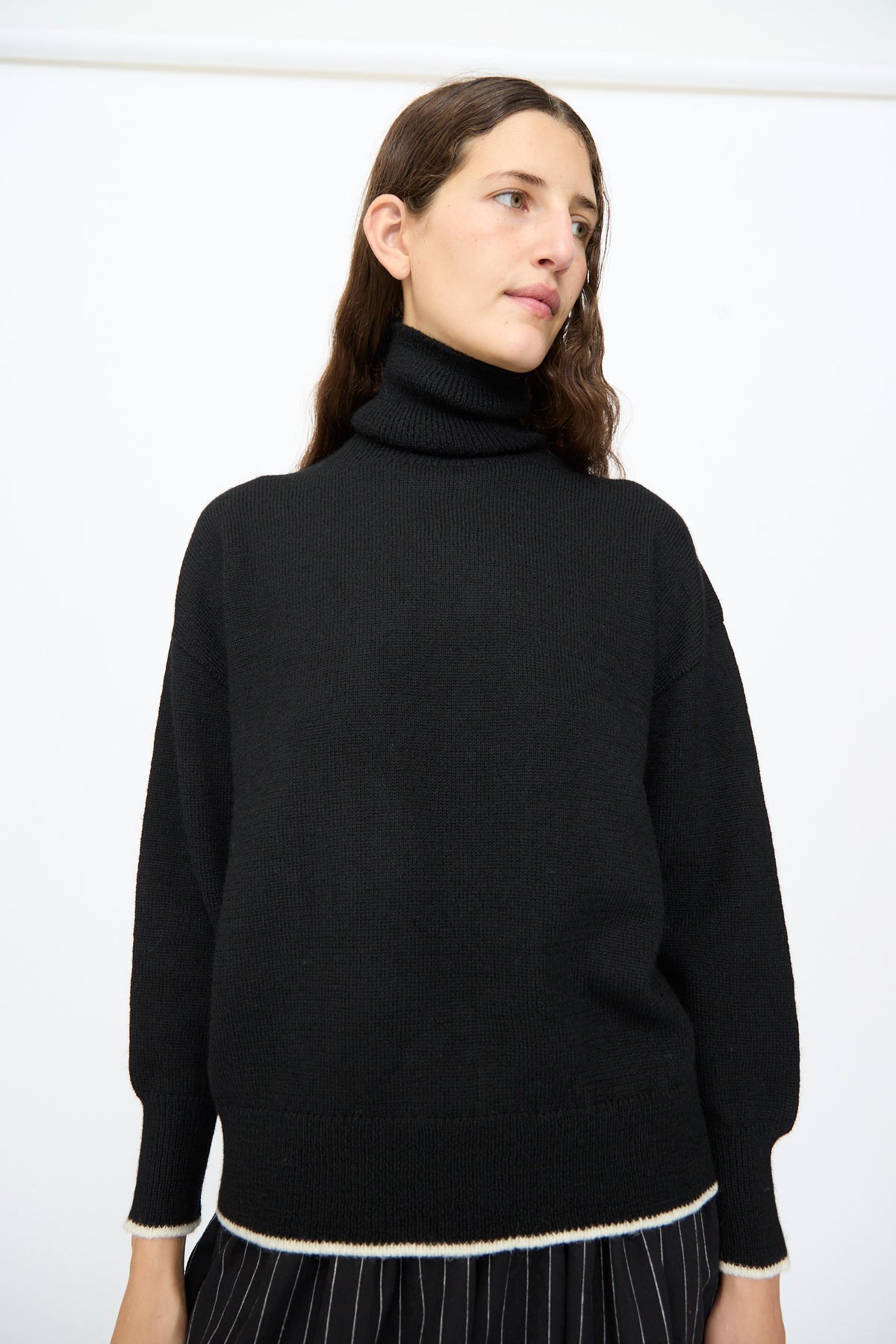Ichi Antiquités Wool Pullover in Black and White, a black wool turtleneck sweater with white trim at the cuffs and hem.