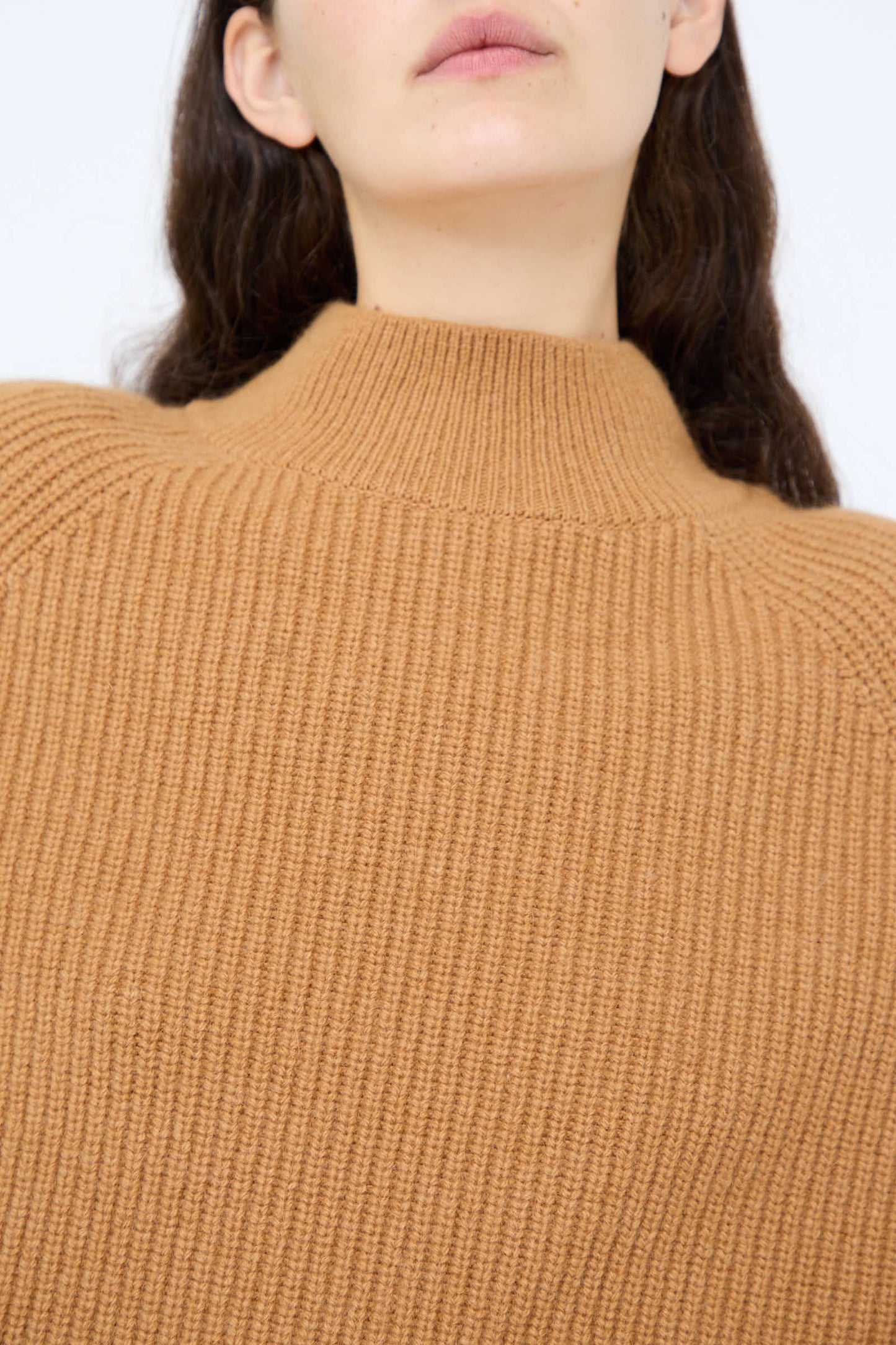 A person with long dark hair is wearing the Wool and Angora Ridge Knitted Pullover in Camel by Ichi Antiquités, which features a relaxed fit and a high crew neckline.