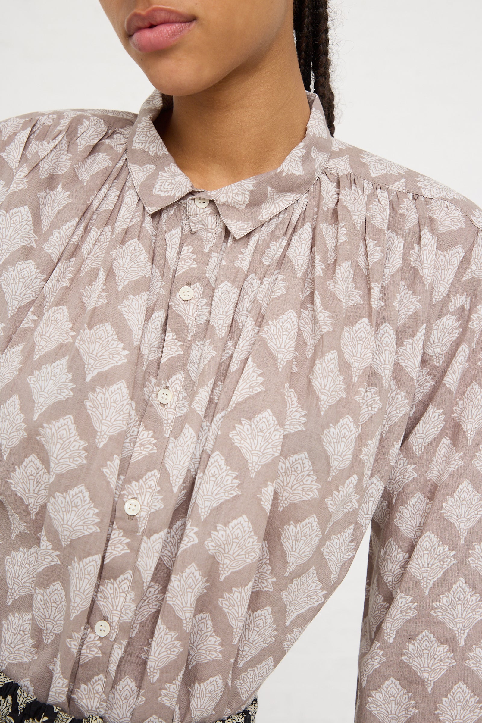 Close-up of a woman wearing an Ichi Antiquités Woven Cotton Indian Block Print Shirt in Beige with a focus on the collar and button details.