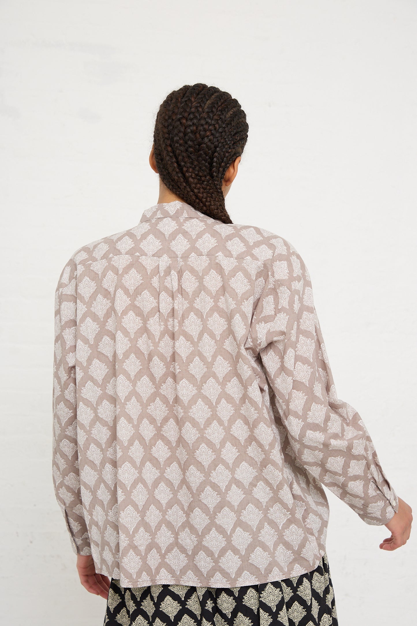 Person with braided hair wearing an Ichi Antiquités Woven Cotton Indian Block Print Shirt in Beige, photographed from behind.