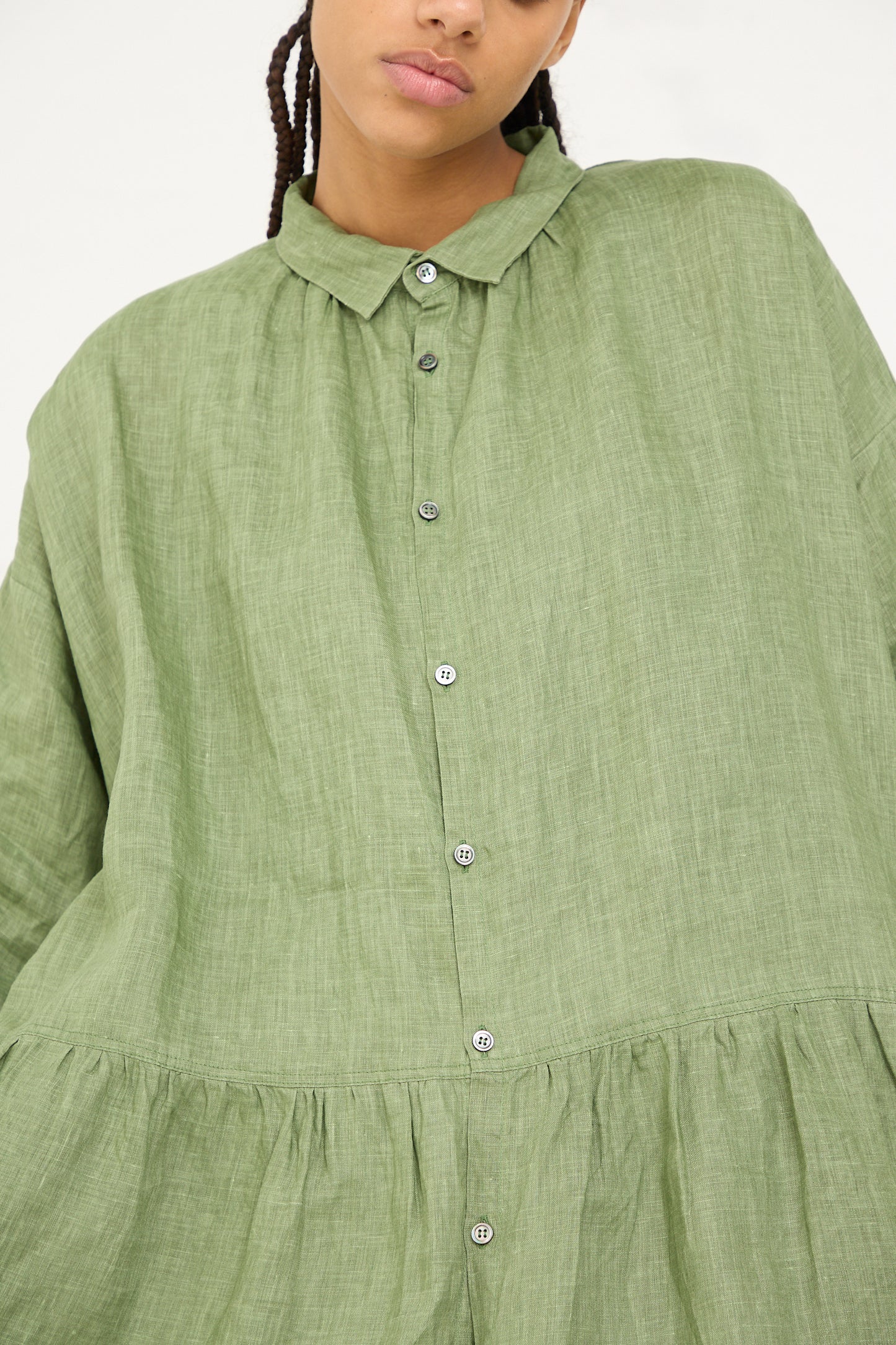 Close-up of a woman wearing an Ichi Antiquités Woven Linen Dress in Green with button details.