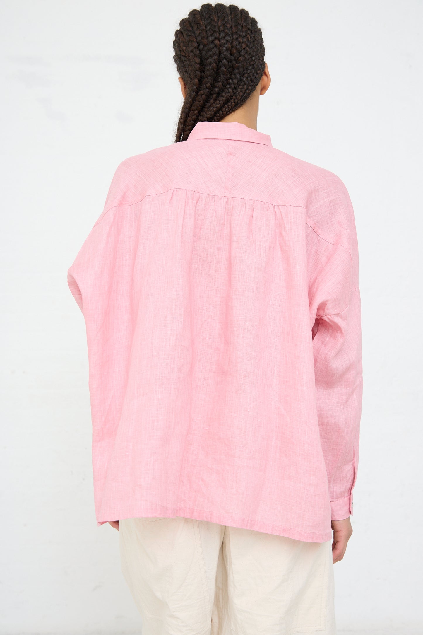 Person standing with back to the camera wearing a Ichi Antiquités Woven Linen Shirt in Pink and beige pants.