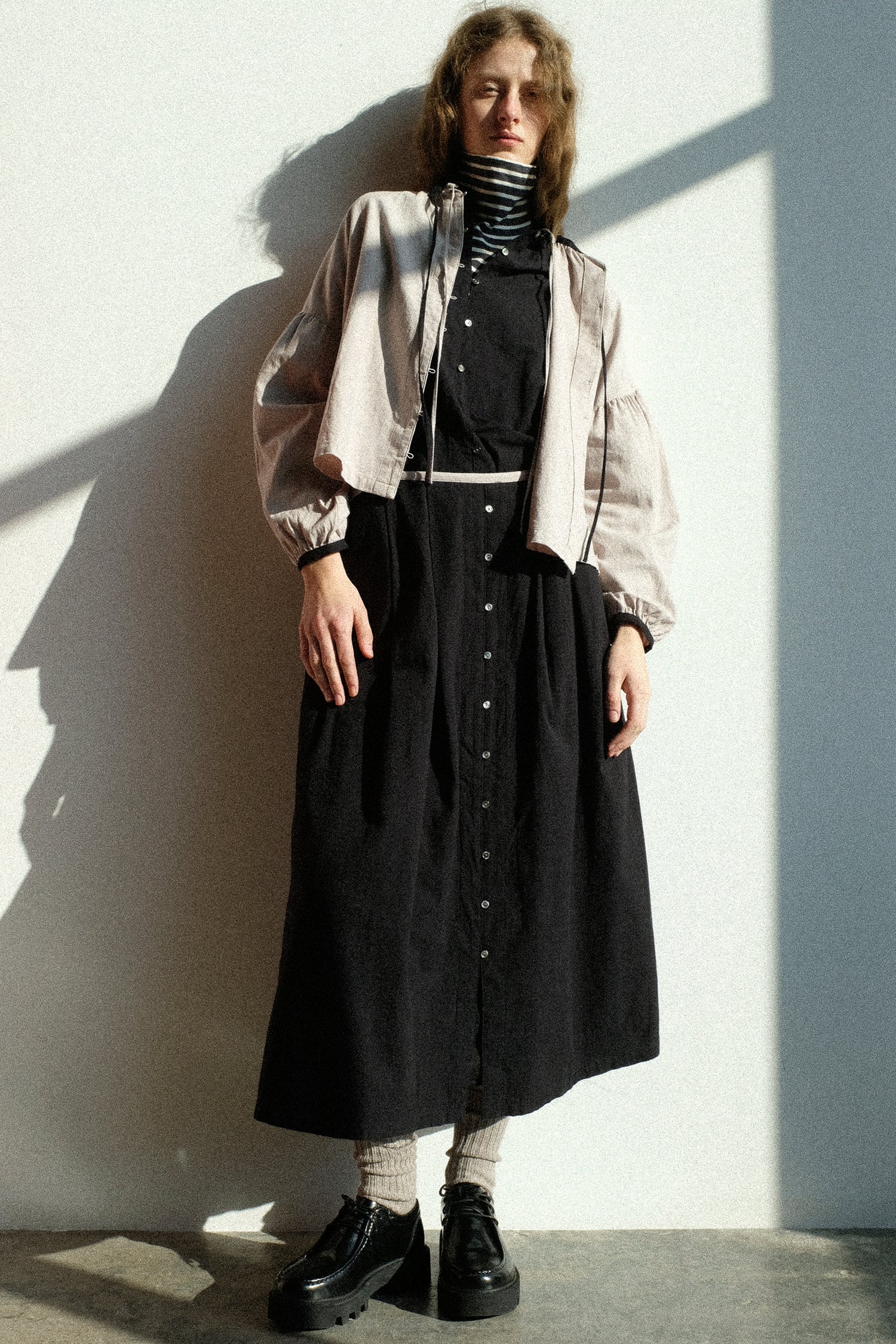 A woman wearing Ichi Antiquites Cotton Cashmere Viyella Shirt in Natural, Cotton Cashmere Viyella Dress in Black, and the Cotton Cashmere Viyella Skirt in Black.