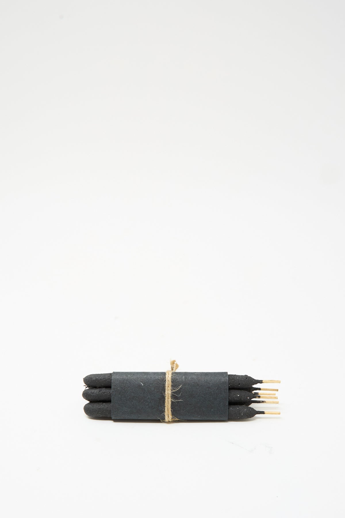 Six dark Chacrona incense sticks from the Half Dozen Incense Bundles in Chacrona & Jacube collection, bundled together with a black paper band and tied with twine.