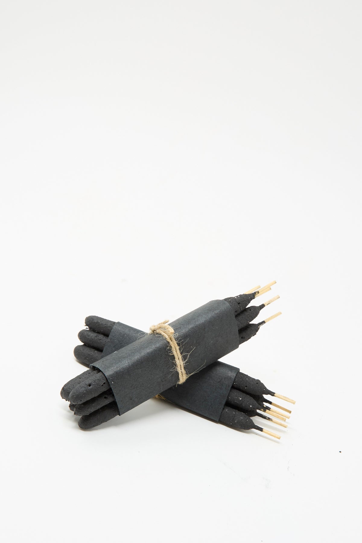 Two bundles of Incausa Half Dozen Incense Bundles in Chacrona & Jacube, each wrapped in black paper and tied with twine.