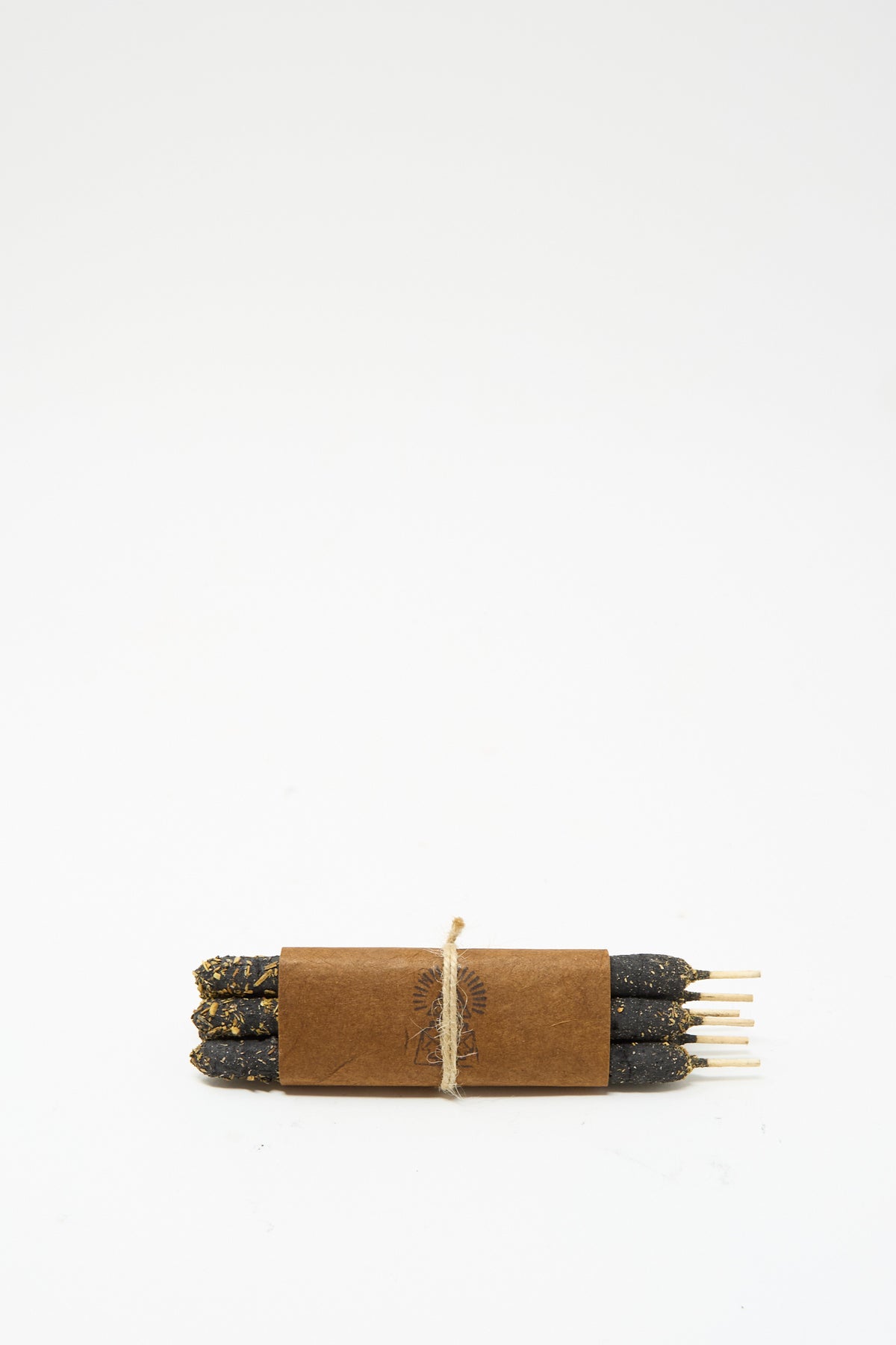 Six dark artisanal Half Dozen Incense Bundles in Palo Santo bundled together with a brown paper wrapper and tied with twine.