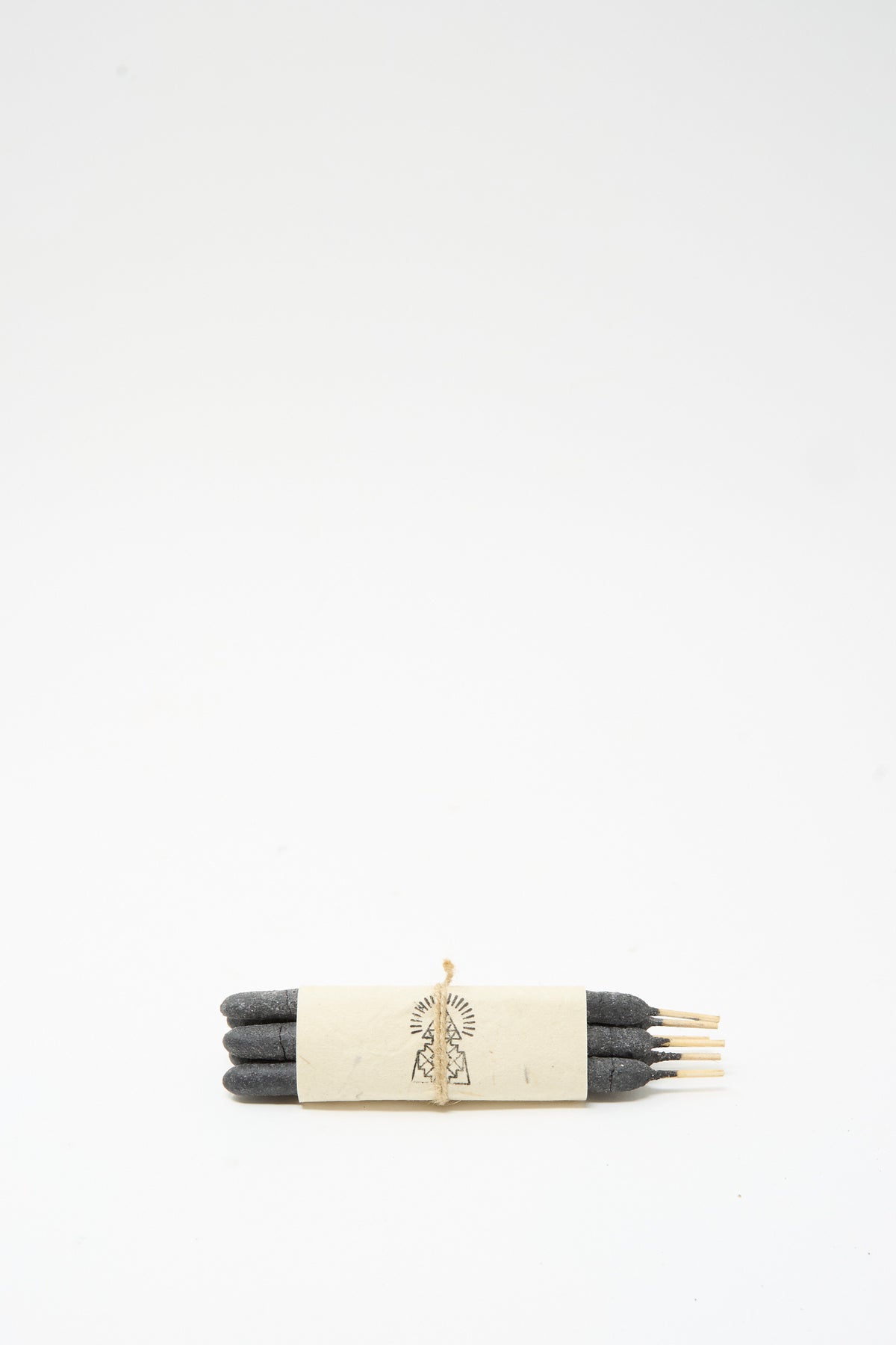Six dark sticks of Half Dozen Incense Bundles in Pure Breu wrapped together with a paper band and twine.