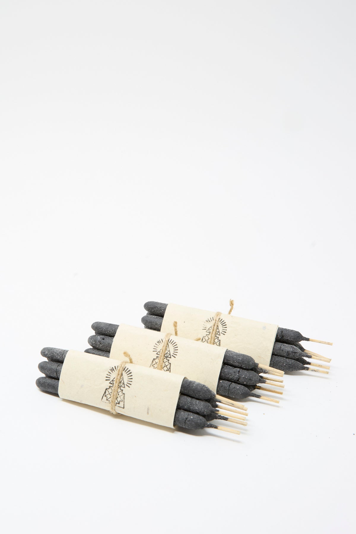 Three Half Dozen Incense Bundles in Pure Breu, each wrapped in a paper band with a printed mountain illustration and tied with string.