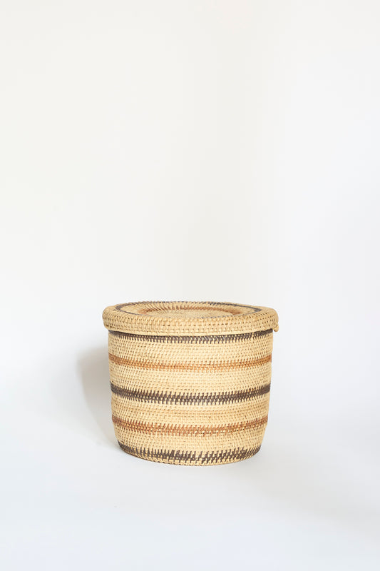 Motorohina Basket with Yanomami Stripe Painting Mixed by Incausa, featuring handwoven horizontal brown and beige stripes with a lid, placed against a plain white background.