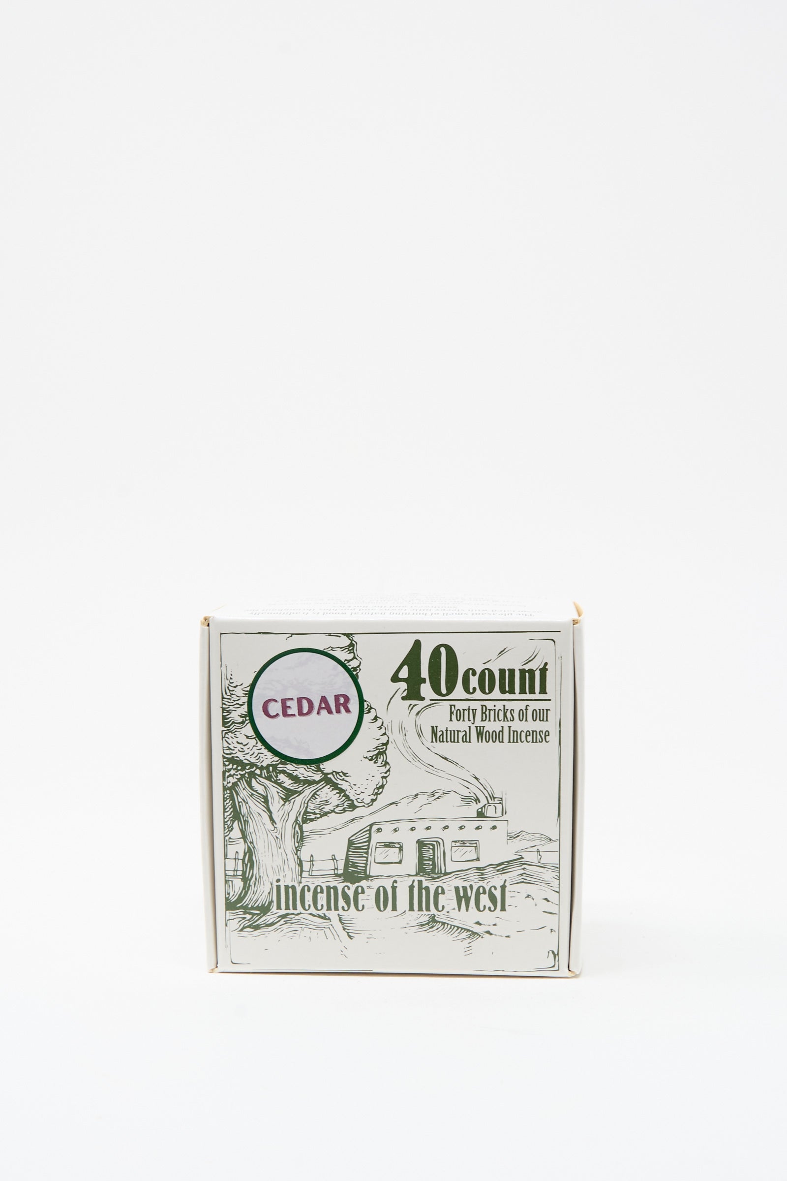 The Cedar Incense Box by Incense of the West contains 40 cedar wood incense bricks with a rich cedar scent and comes in packaging featuring a tree and cabin, inspired by New Mexican clay designs.