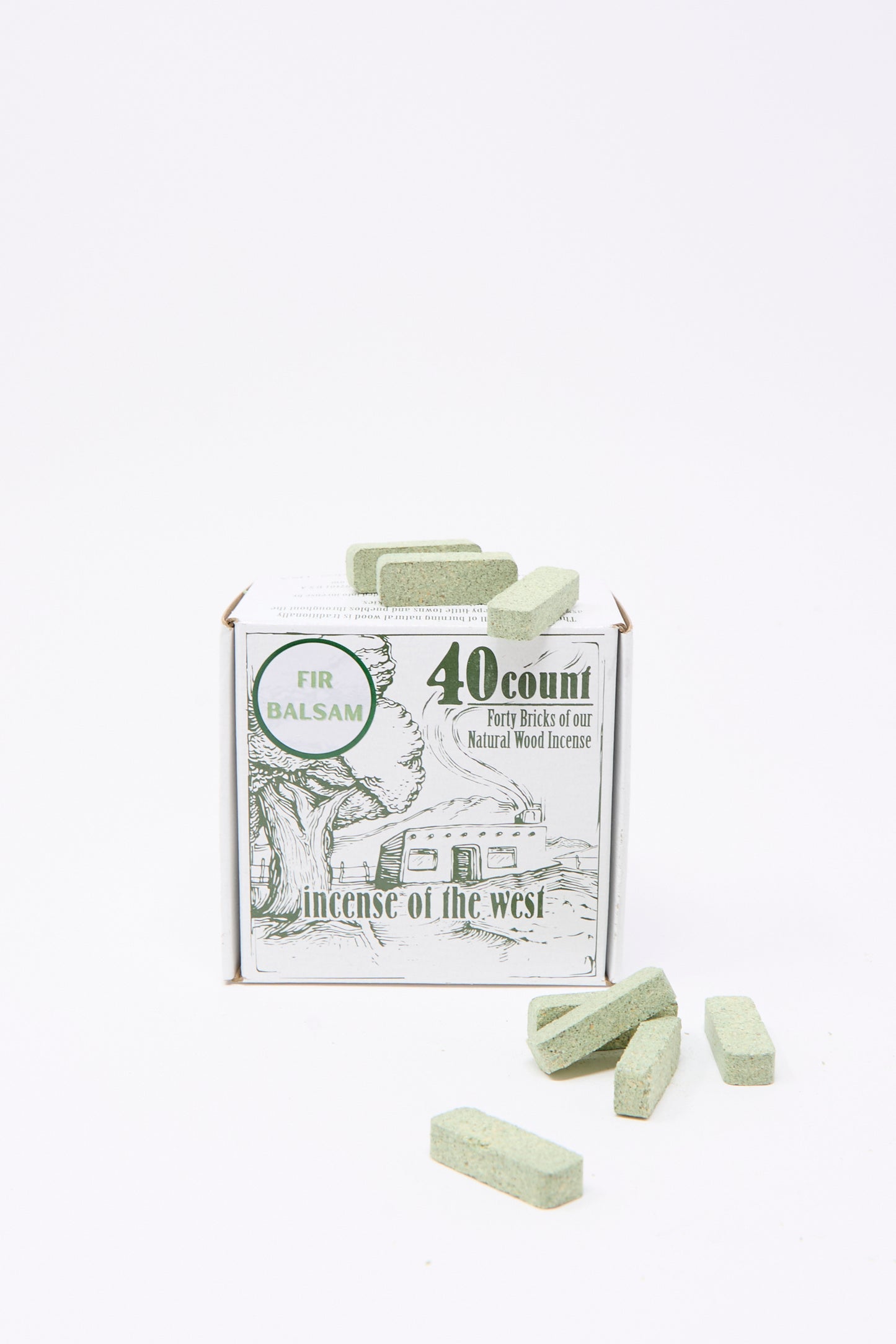 The Fir Balsam Incense Box by Incense of the West contains 40 green incense bricks, shown stacked and displayed before the box. Bring the fresh scent of evergreen forests to your space—ideal for use with incense burners.