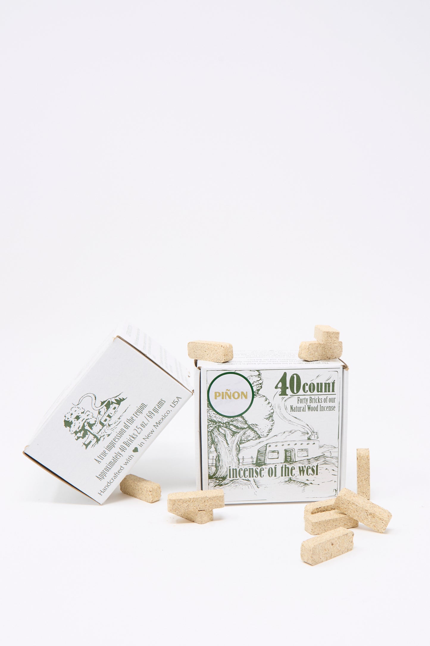 The Incense of the West Piñon Incense Box features 40 piñon pine incense bricks, ideal for traditional New Mexican clay incense burners. Several bricks are displayed around the box for easy use.