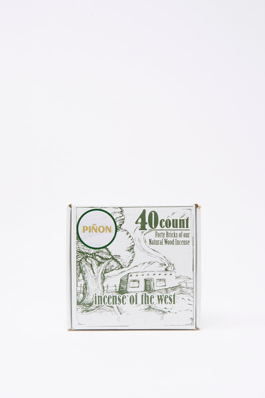 The Piñon Incense Box by Incense of the West contains 40 sticks, packaged with a tree and trailer design—ideal for use in incense burners or traditional New Mexican clay holders.