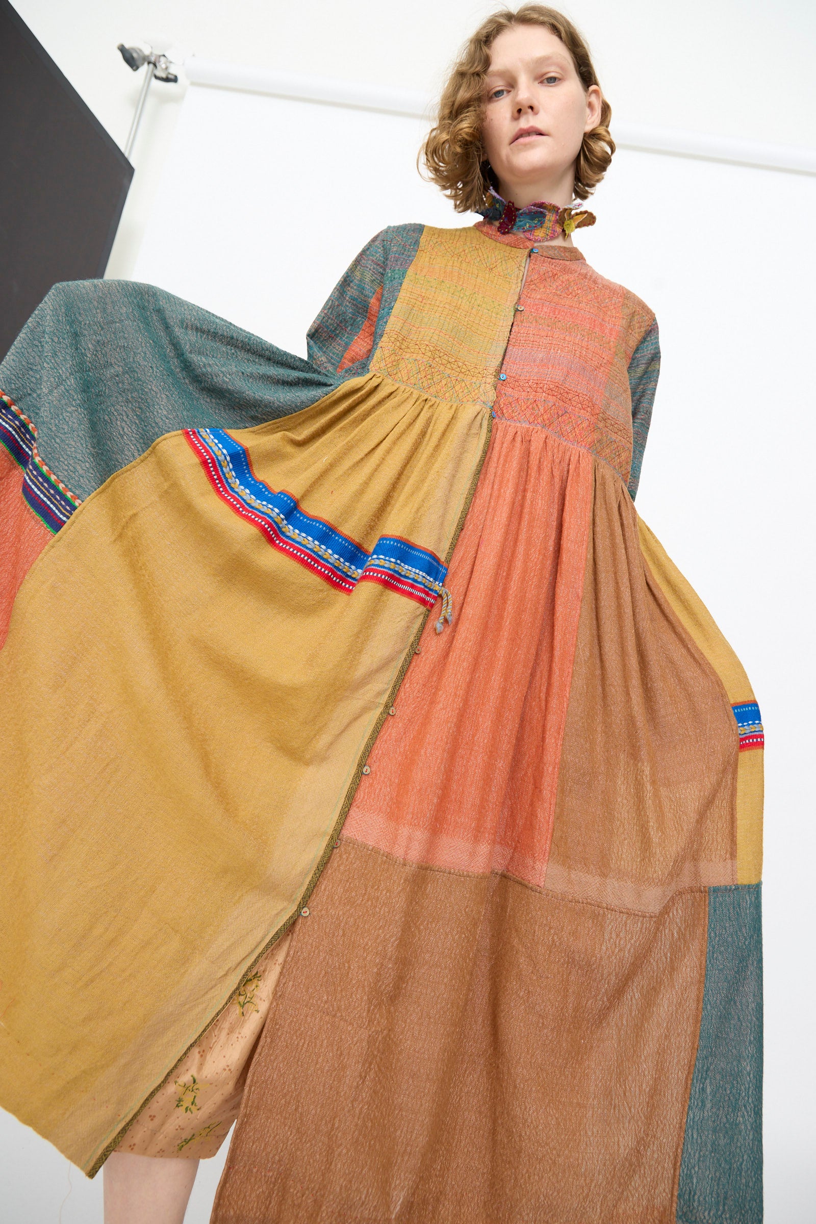 A person wearing the Injiri Bhujodi Wool and Silk Boro Jacket in Multi is standing against a plain white background and looking at the camera.
