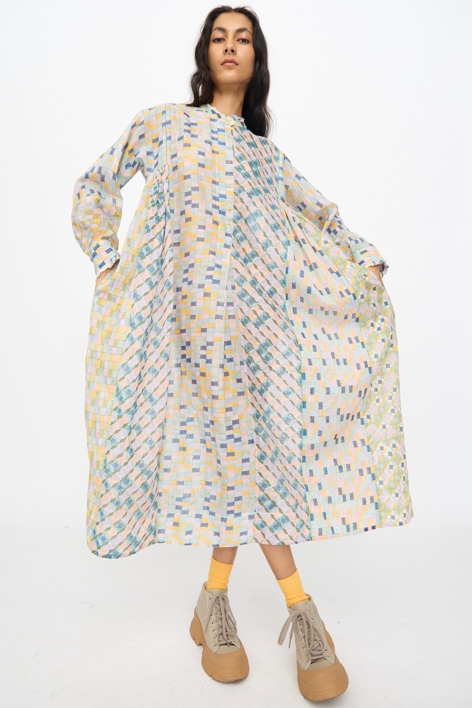 Model wearing Injiri's Blockprint Chanderi Trumpet Dress in Blue Yellow Multi, paired with yellow socks and beige platform shoes, standing against a plain white background.