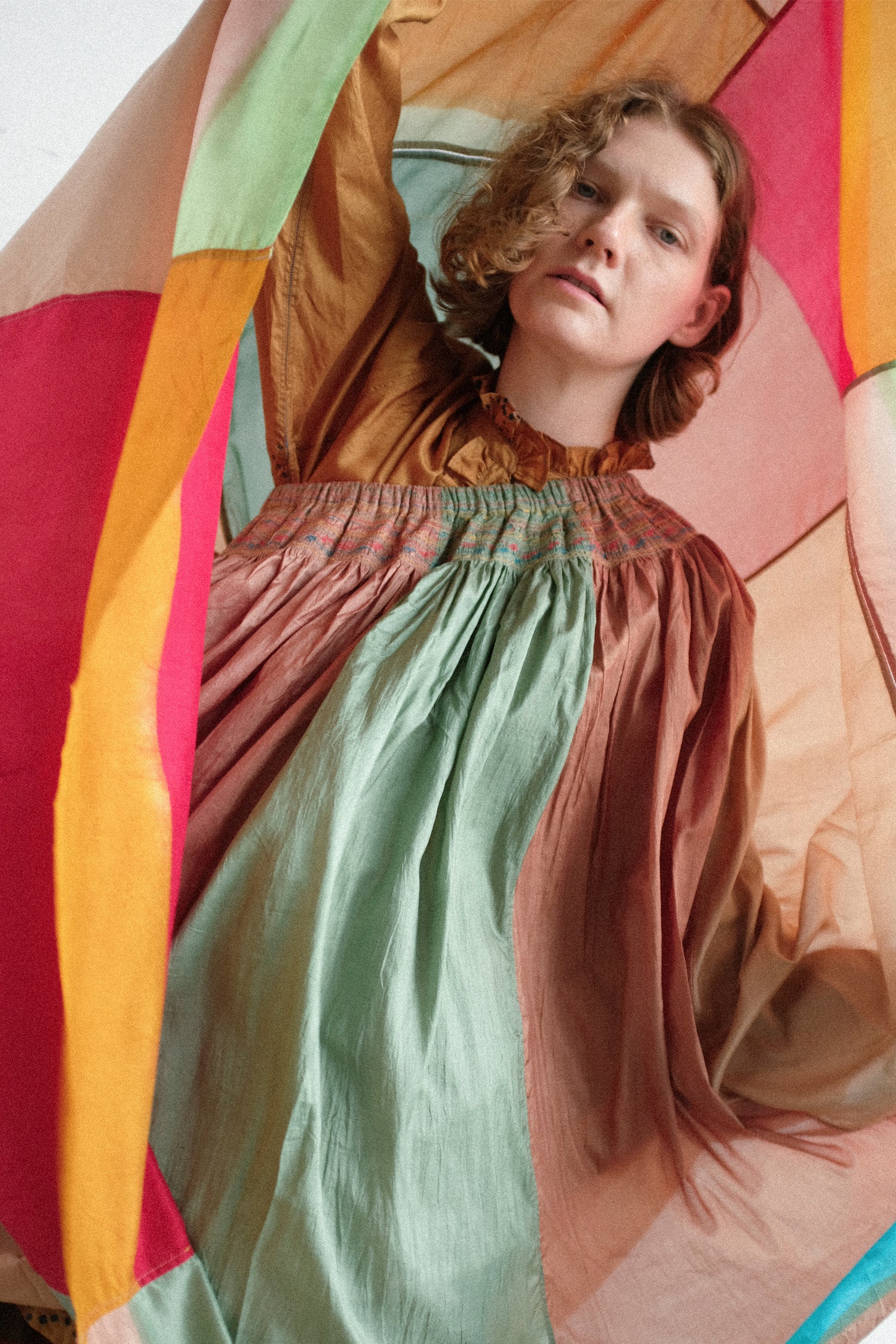 A model holding up Injiri's Clamp Dyed Silk Cotton Alisha Skirt in Multi behind her head.