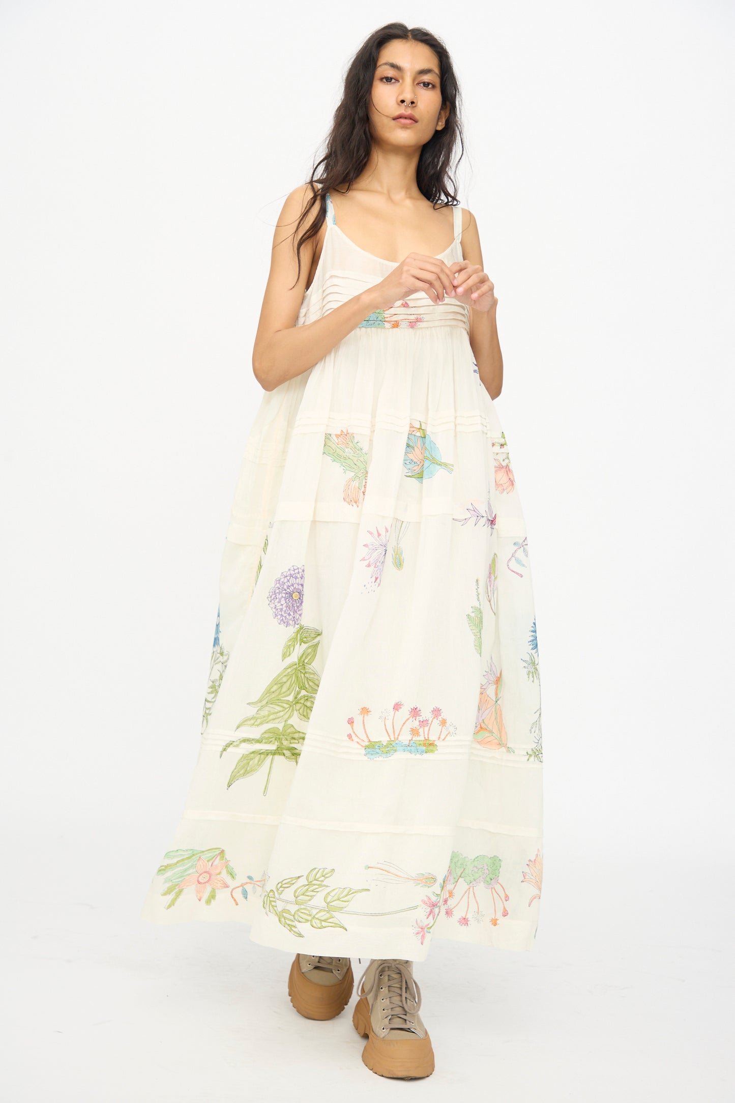 A woman models Injiri’s Cotton Silk Blockprint Hazel Slip in White Floral, styled with tan lace-up shoes, against a plain white background.