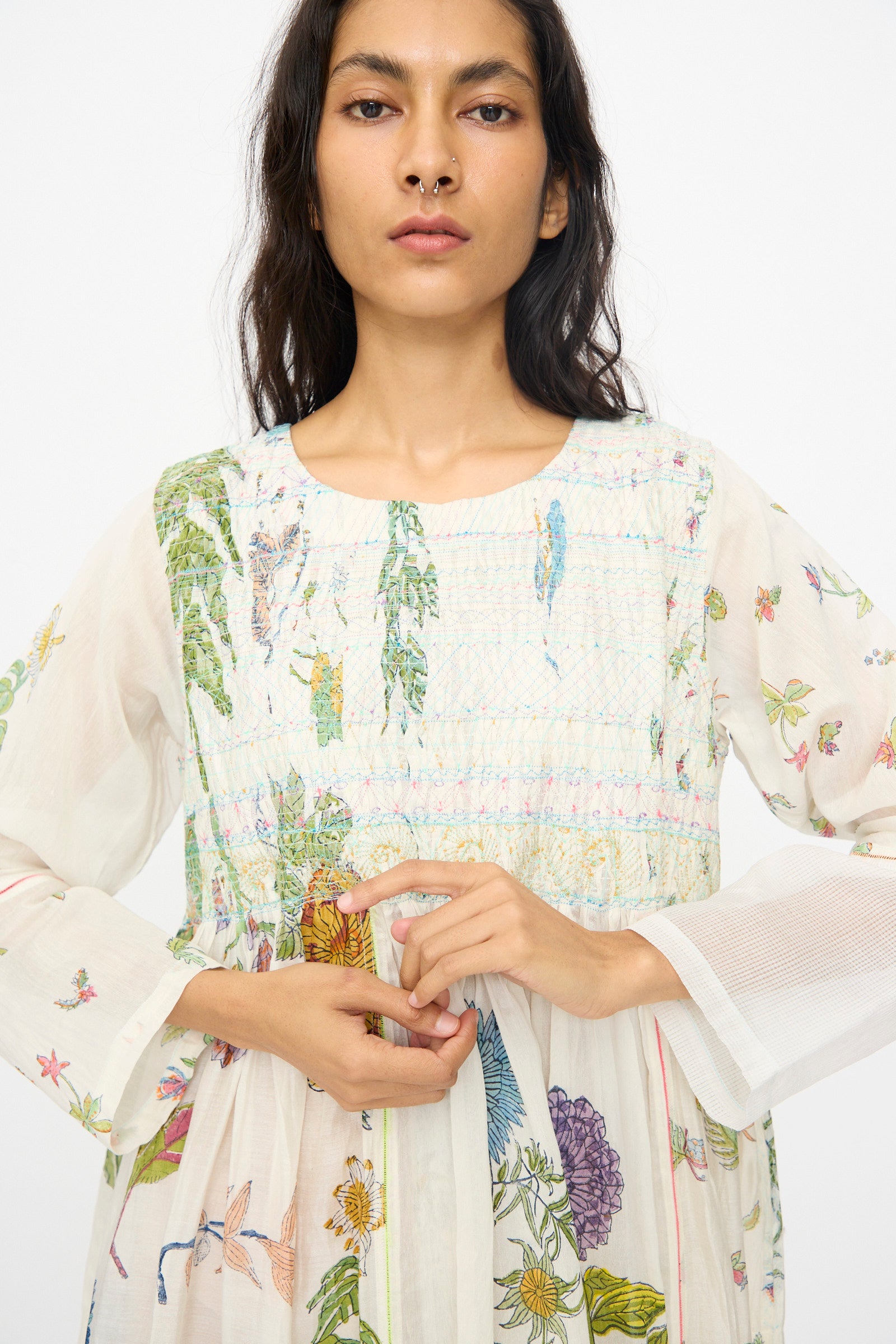 A woman wearing the Injiri Cotton Silk Blockprint Nazma Dress in White stands against a plain white background.