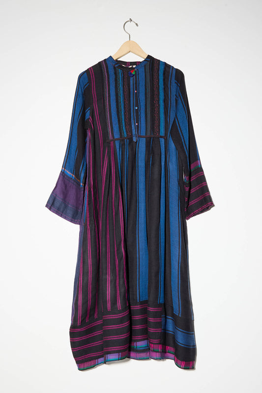 A long-sleeved, knee-length Wool Dress in Stripe Blue and Red by Injiri hangs on a wooden hanger against a white background.