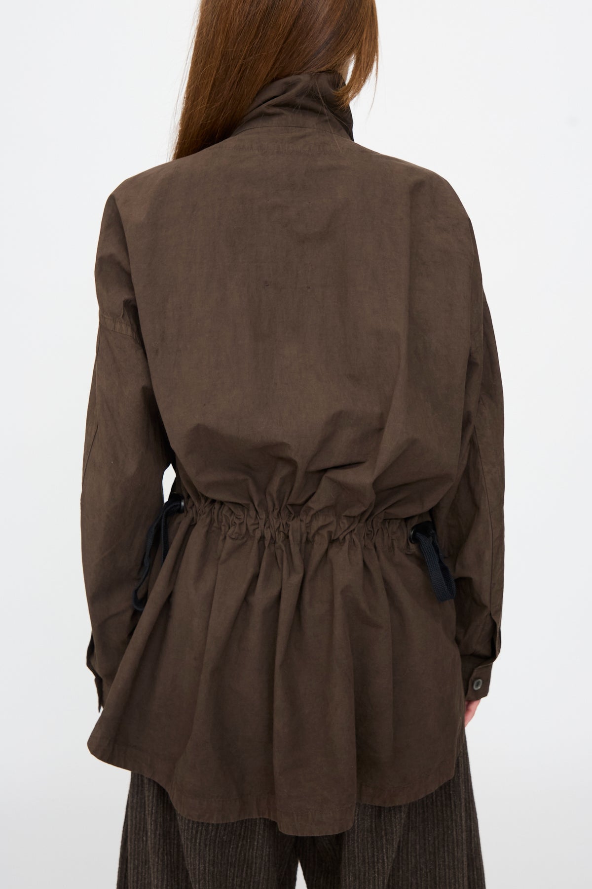 Rear view of the Jan-Jan Van Essche Cotton Wool Shirt #110 in Doro Zome, an oversized brown cotton wool blend shirt featuring a drawstring waist with black ties.