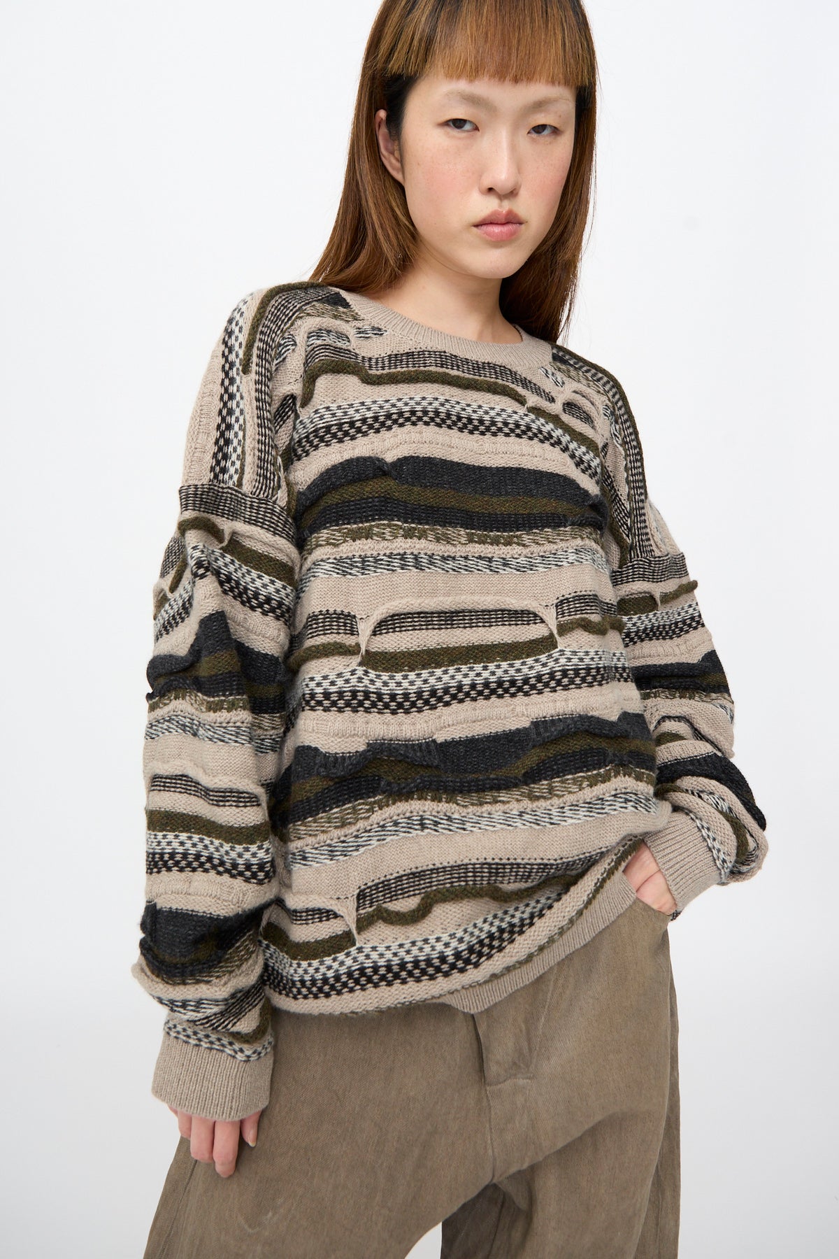Jan-Jan Van Essche Super Fine Wool Knit Sweater #80 in Light Variation: an oversized, multi-textured sweater with beige, green, and black horizontal stripes and recurring horizontal cutout details.