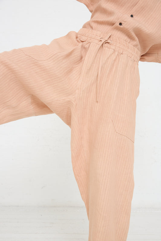 The woman is wearing Jan-Jan Van Essche's Woven Linen Trouser in Ume (Pink).