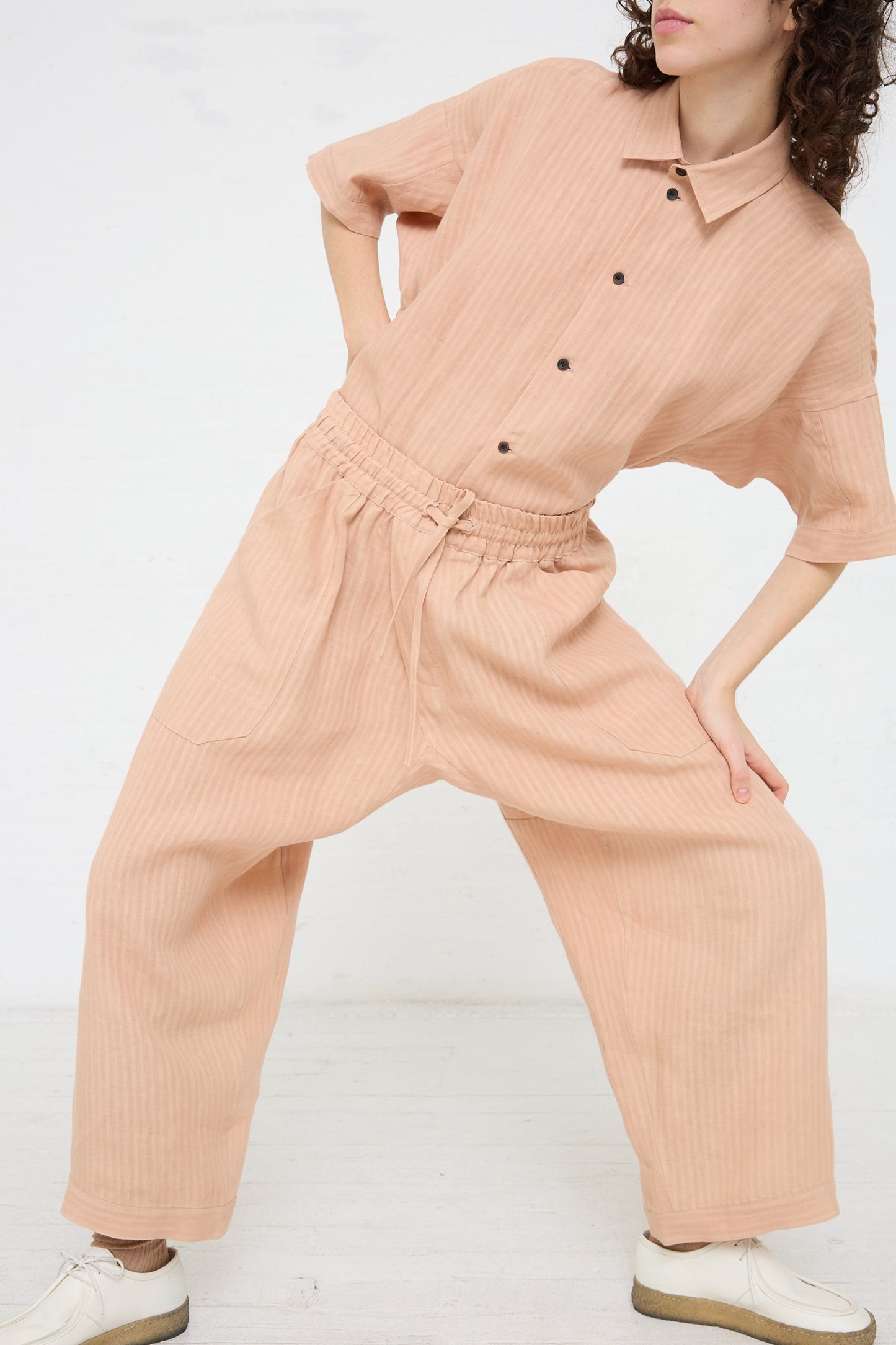 The model is wearing a Woven Linen Trouser in Ume by Jan-Jan Van Essche jumpsuit with elasticated waist.