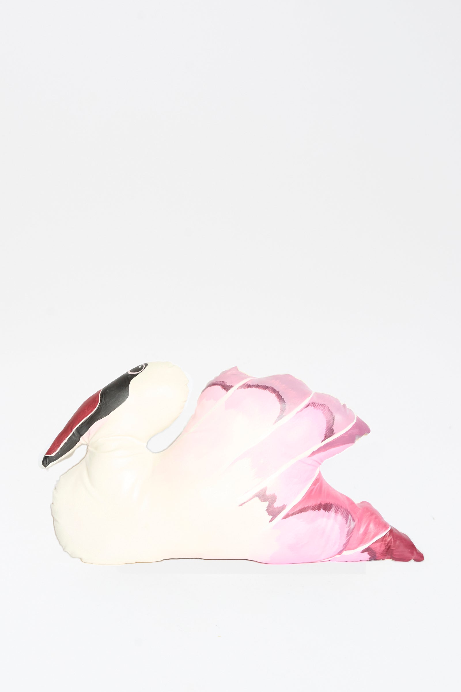The Hand Painted Swan Pillow I by Jess Feury features a white body, pink wings, and a black and red beak. This handmade pillow is shown against a plain white background.