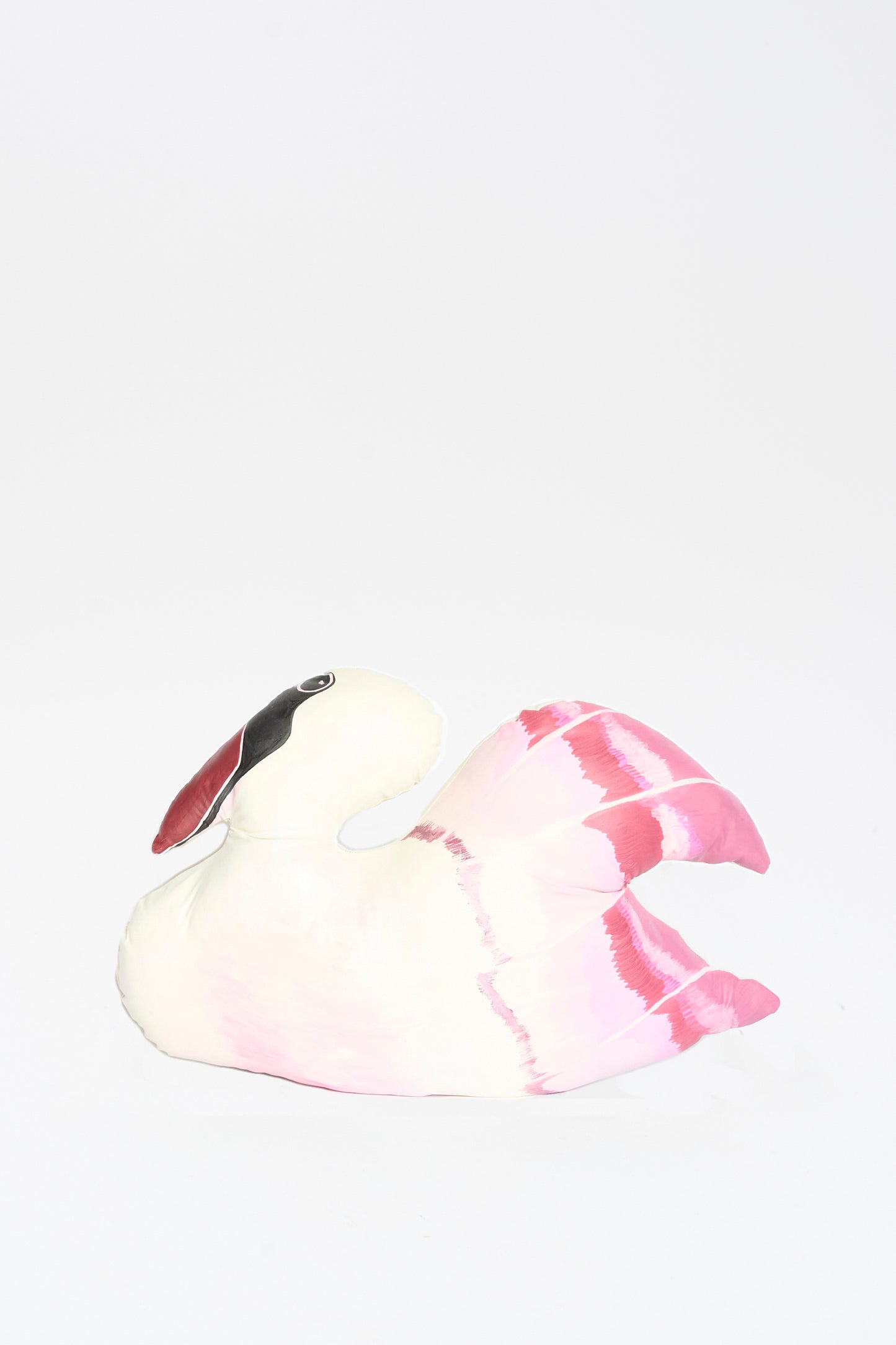 The Hand Painted Swan Pillow II by Jess Feury features a white and pink swan design with a black patch near its eye, shown against a plain white background.