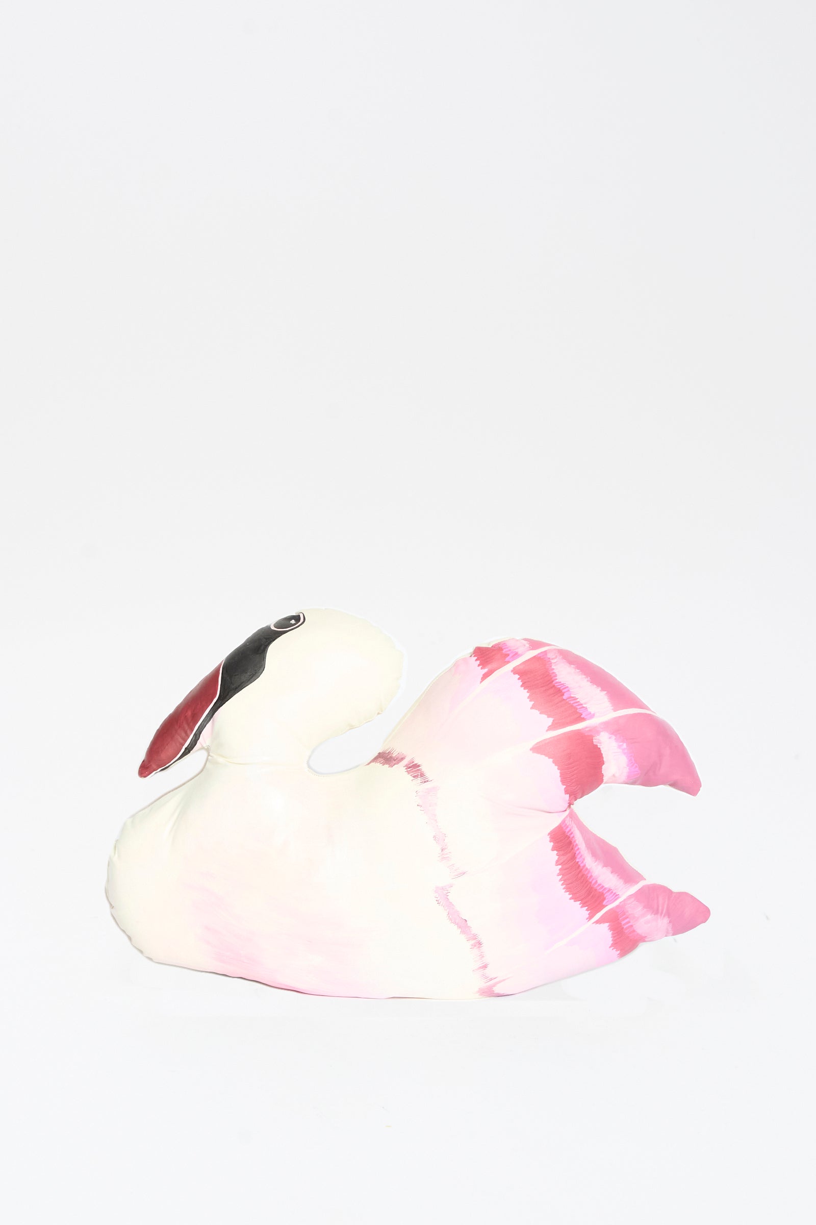 The Hand Painted Swan Pillow II by Jess Feury features a white and pink swan design with a black patch near its eye, shown against a plain white background.