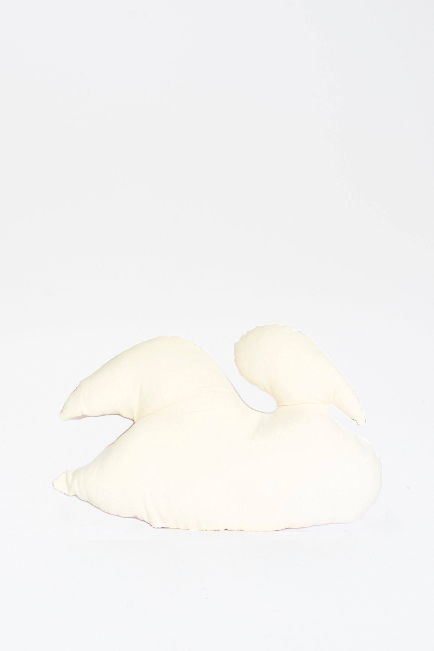 The Hand Painted Swan Pillow II by Jess Feury facing away, displayed against a plain white background. 