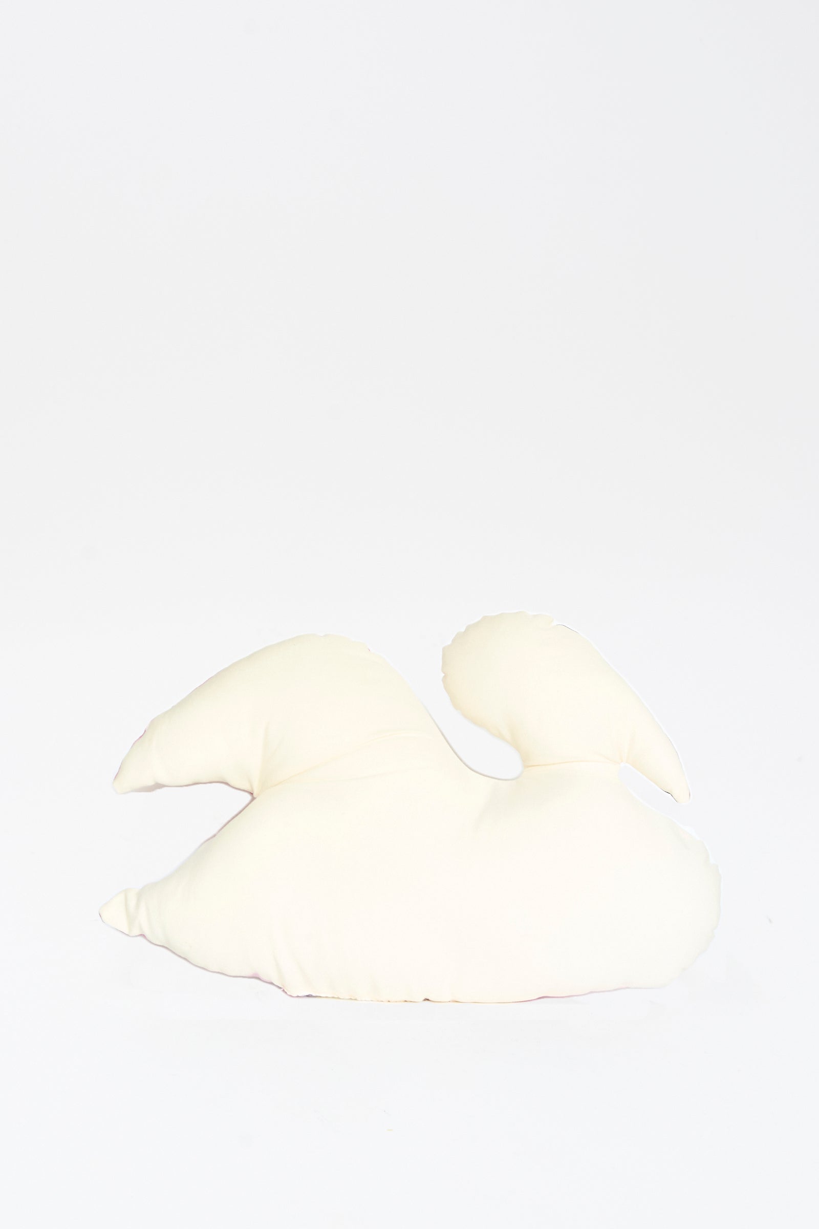 The Hand Painted Swan Pillow II by Jess Feury facing away, displayed against a plain white background. 