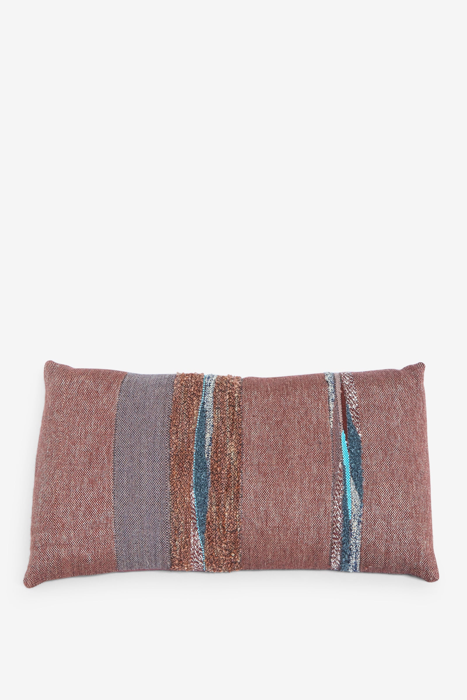 The Jess Feury Handwoven Rock Slab Pillow in Topaz and Copper is a rectangular throw pillow with a textured surface, showcasing horizontal stripes in brown, gray, and blue against a  white background. 