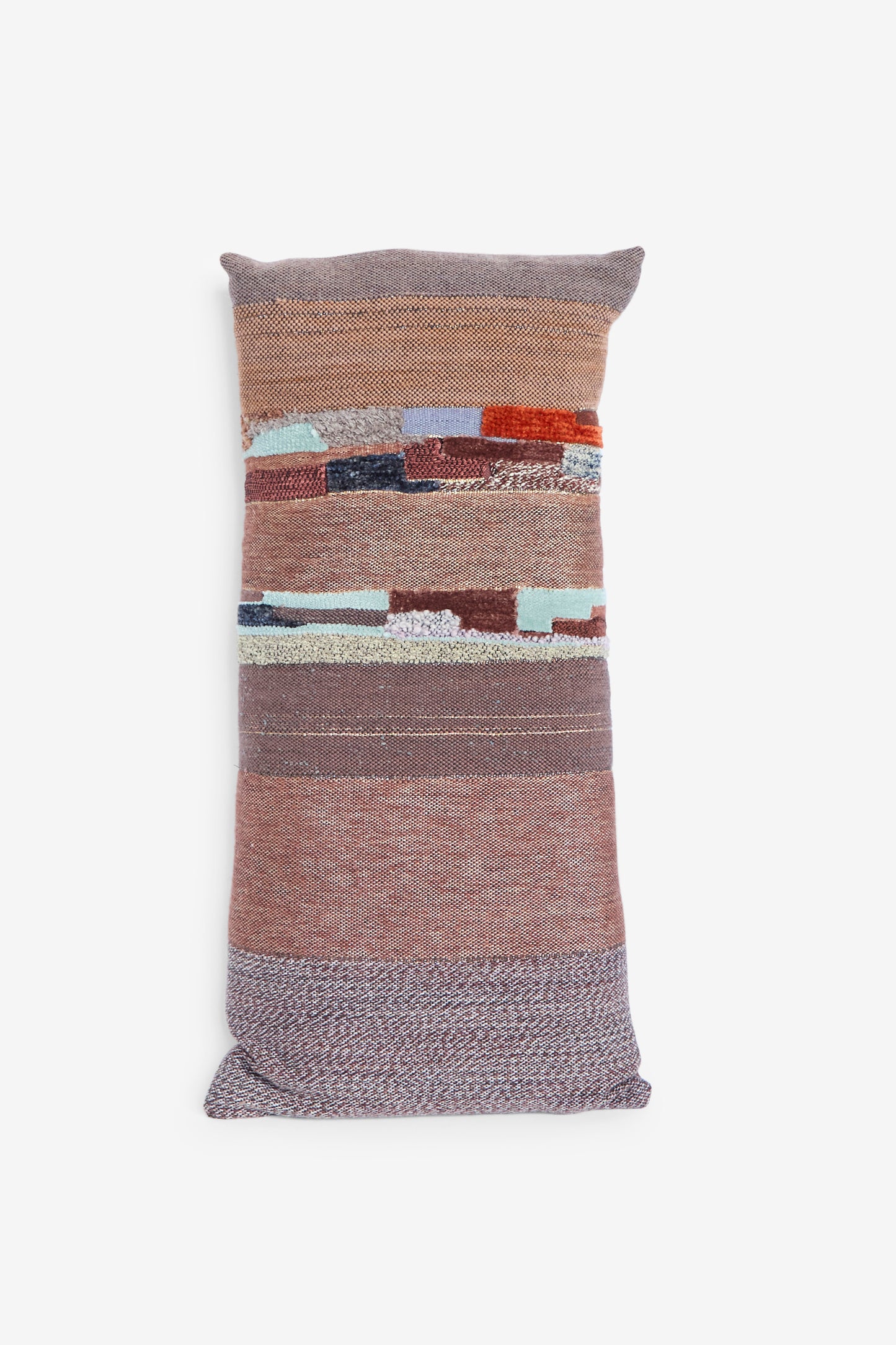 The Handwoven Tapestry Color Block Pillow in Copper and Rust by Jess Feury features a patchwork design of textured, colored horizontal stripes on a white background, handmade in California.