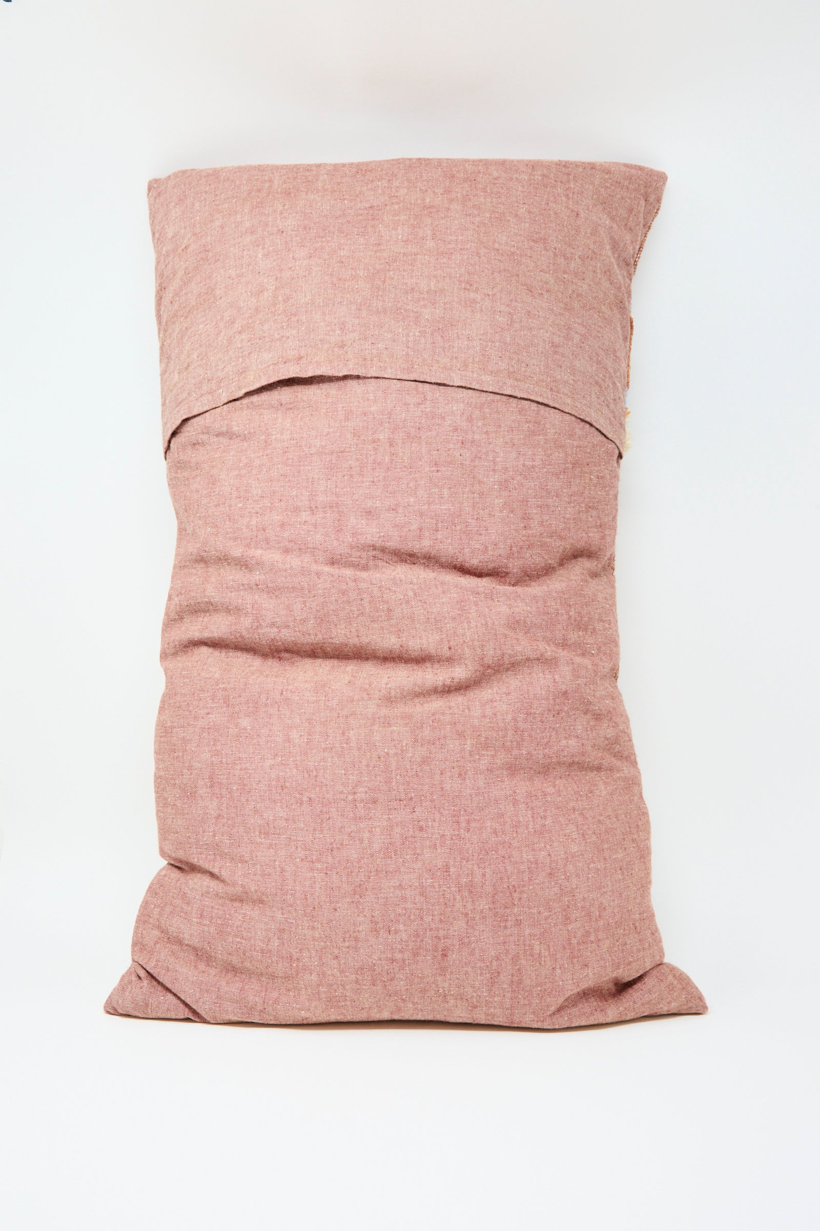 The Jess Feury Woven Colorblock Pillow in Persimmon and Clay features a handwoven rectangular design with a textured, light reddish-pink cover, shown against a plain white background.