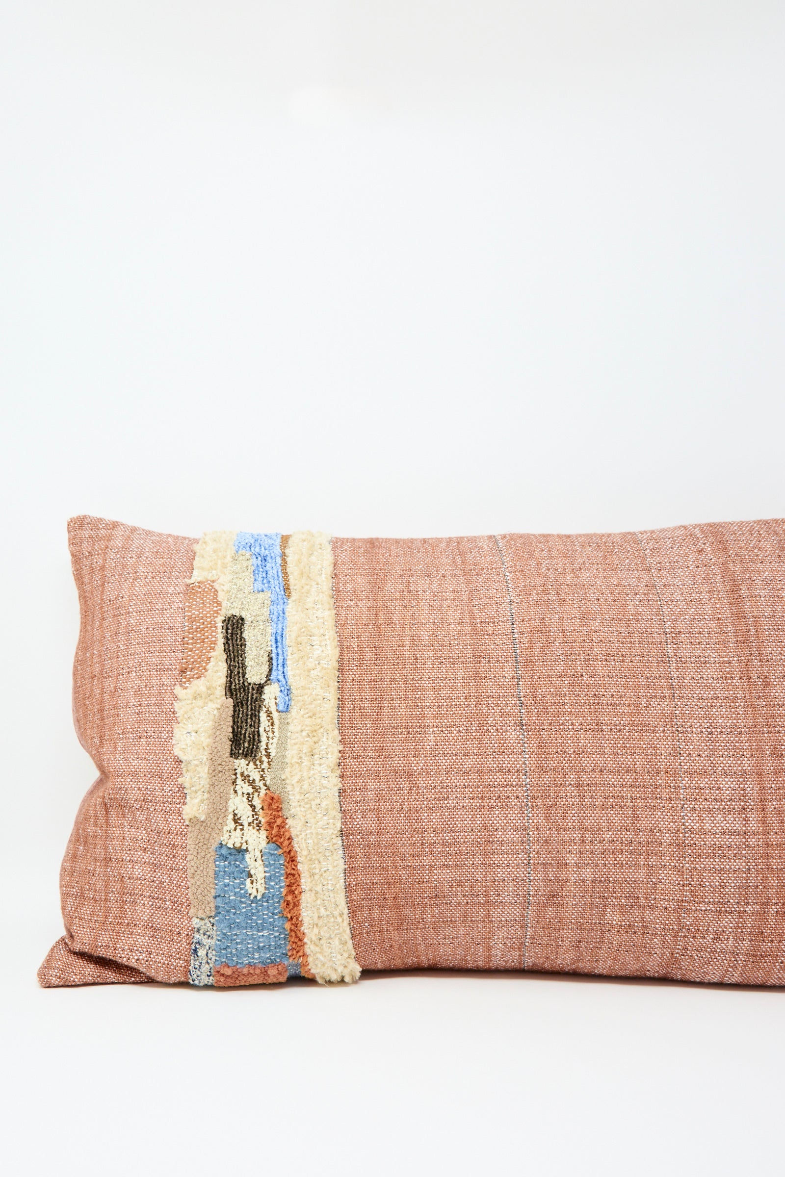 The Jess Feury Woven Colorblock Pillow in Persimmon and Clay features an abstract multicolor pattern on one side, handwoven from sustainable fibers and shown against a plain white background.