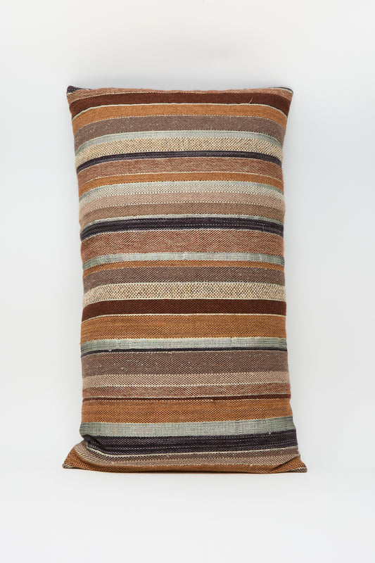 The Jess Feury Woven Pillow in Rust and Terracotta Stripe is handwoven, rectangular, featuring horizontal stripes in warm earth tones on a white background, and crafted from sustainable fibers.