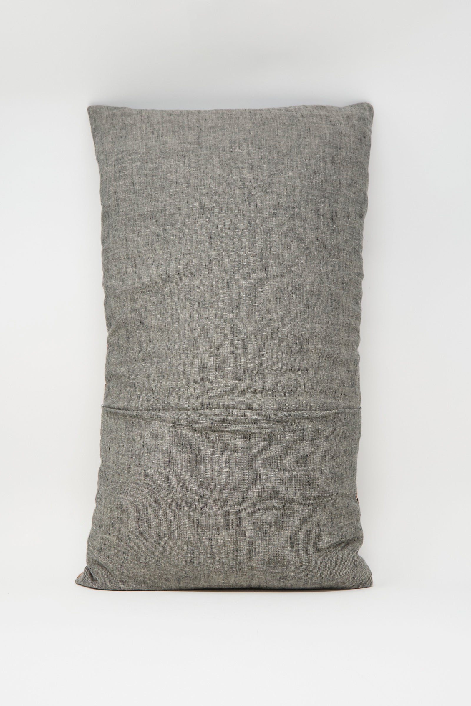 A rectangular Woven Pillow in Rust and Terracotta Stripe by Jess Feury, featuring handwoven construction with subtle texture, crafted from sustainable fibers and shown upright against a plain white background.