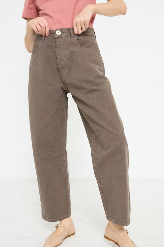 A woman wearing the Jesse Kamm California Wide pants in Mushroom, made from organic cotton in a relaxed fit.