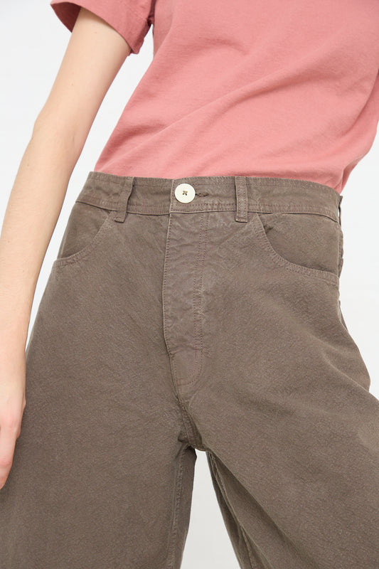 A woman in a pink t-shirt and brown pants, enjoying the Jesse Kamm California Wide in Mushroom fit.