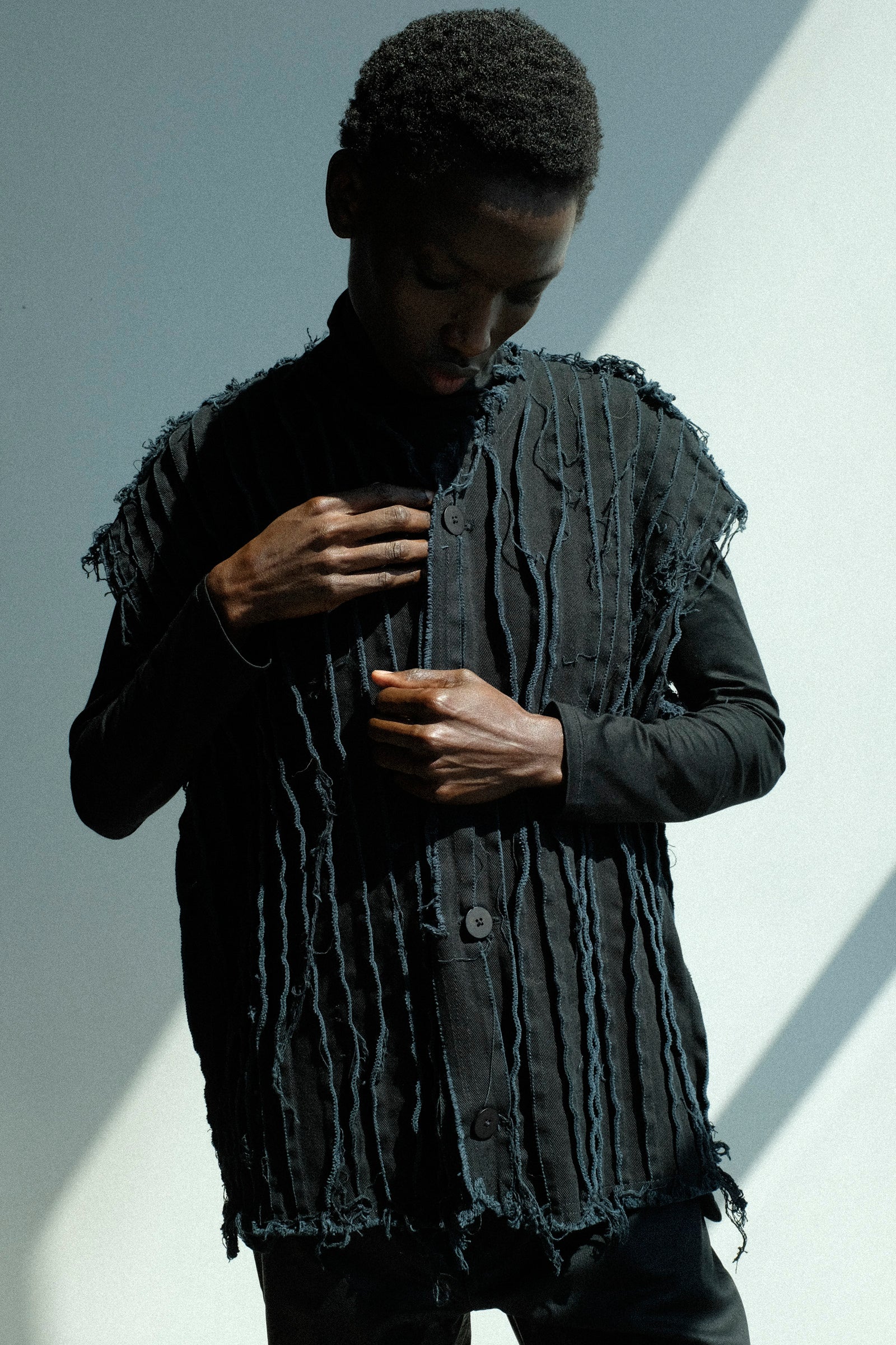 Person wearing a Jesse Kamm's Deadstock 10oz. Denim Baleen Vest in Black against a light background.