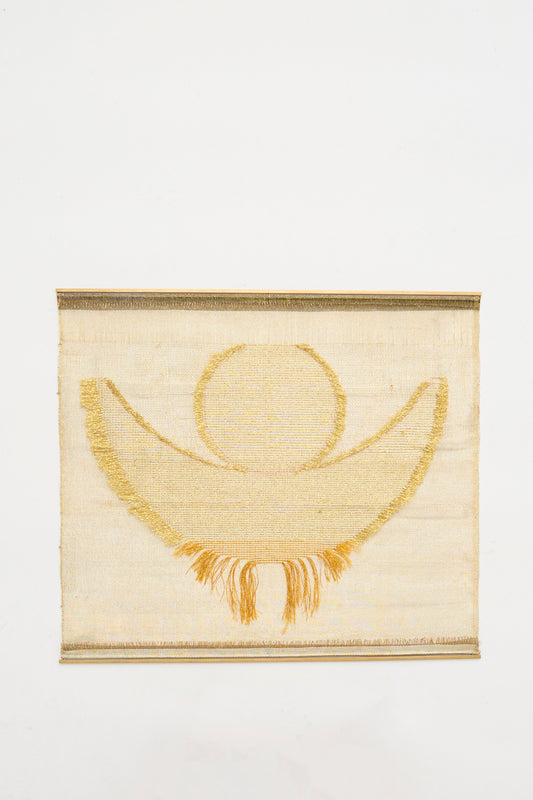 The Hermes Crescent Moon Weaving by Justine Ashbee is a handmade UK wall hanging with a gold circle, crescent moon motif, and short fringe. 