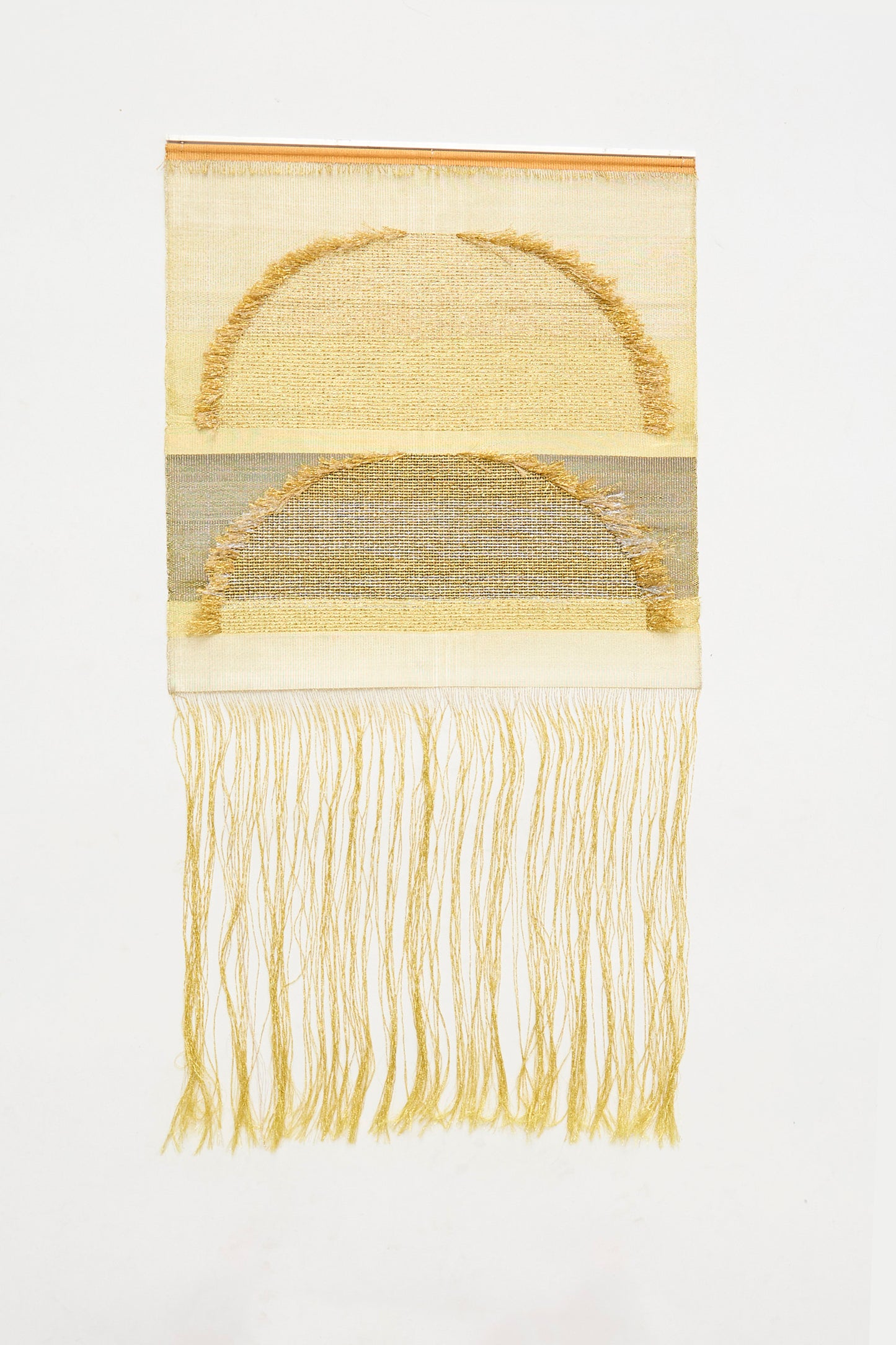 The Two Suns Rising Weaving by Justine Ashbee is a handmade UK textile art piece with two stacked light yellow semicircles and long fringe, creating an elegant rectangular wall hanging for modern interiors.