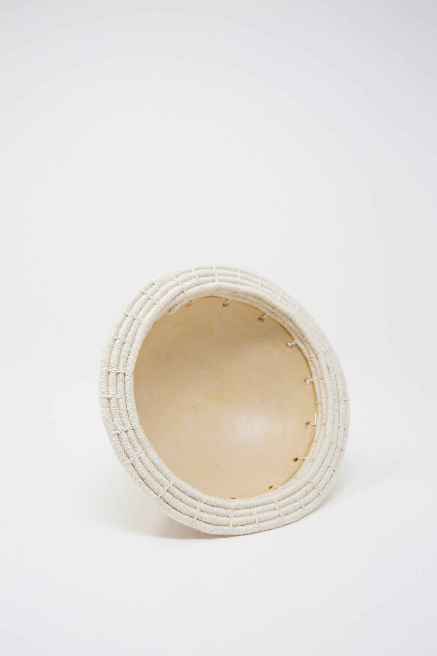 A Decorative Bowl #805 in Tan by Karen Tinney, viewed from the side against a white background, crafted from California stoneware.