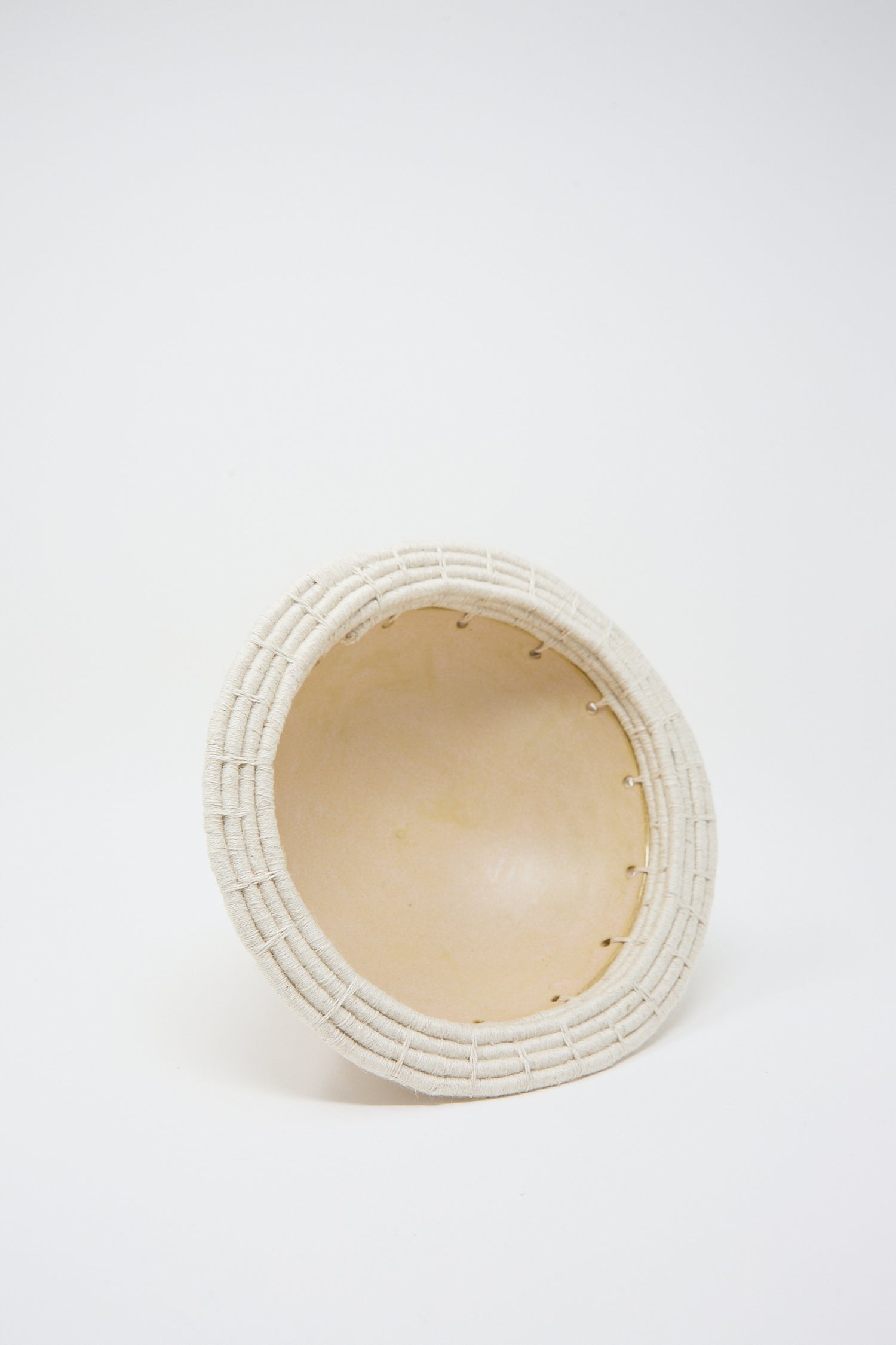 A Decorative Bowl #805 in Tan by Karen Tinney, viewed from the side against a white background, crafted from California stoneware.
