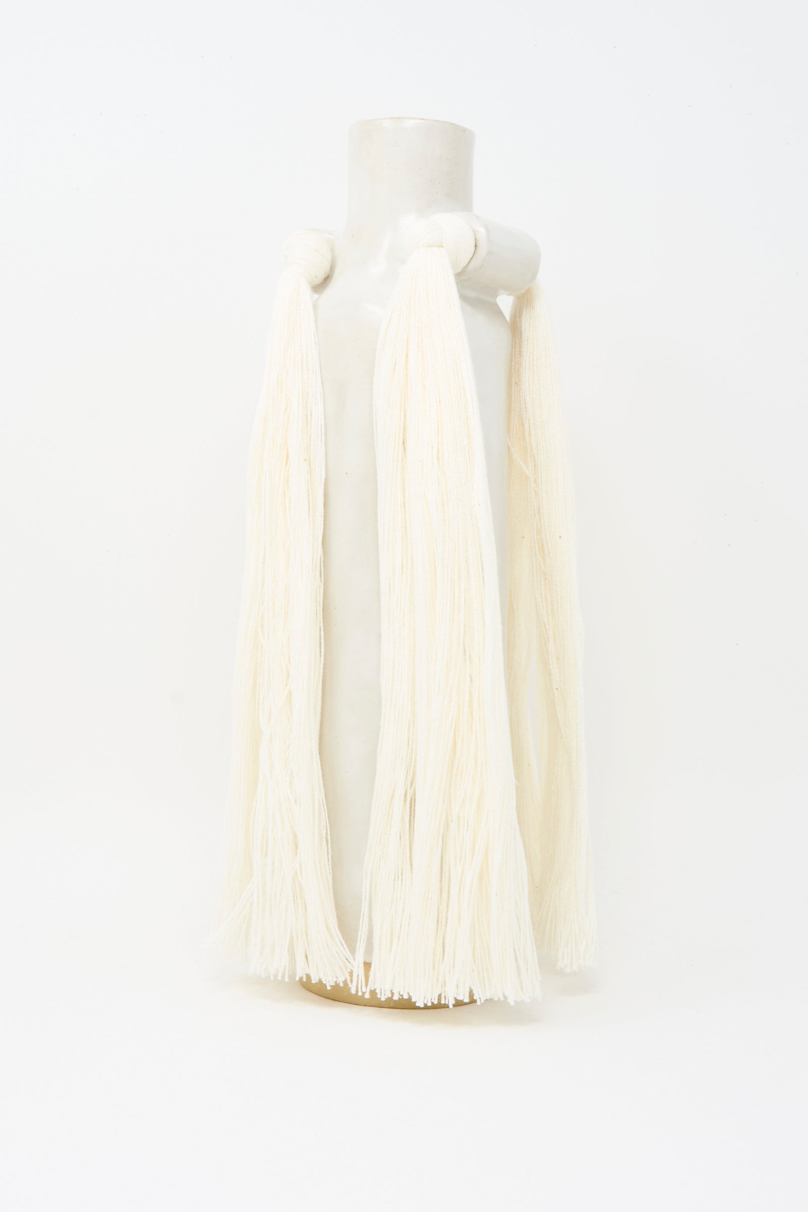 Vase #703 in White by Karen Tinney is a handmade white stoneware vase with two looped handles draped in off-white yarn, crafted in Vermont and shown against a plain white background.