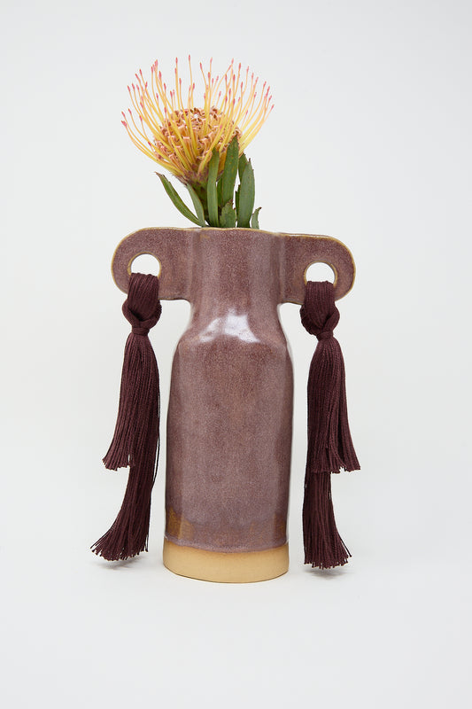Karen Tinney's Vase #606 in Burgundy with tassel handles and a single protea flower.