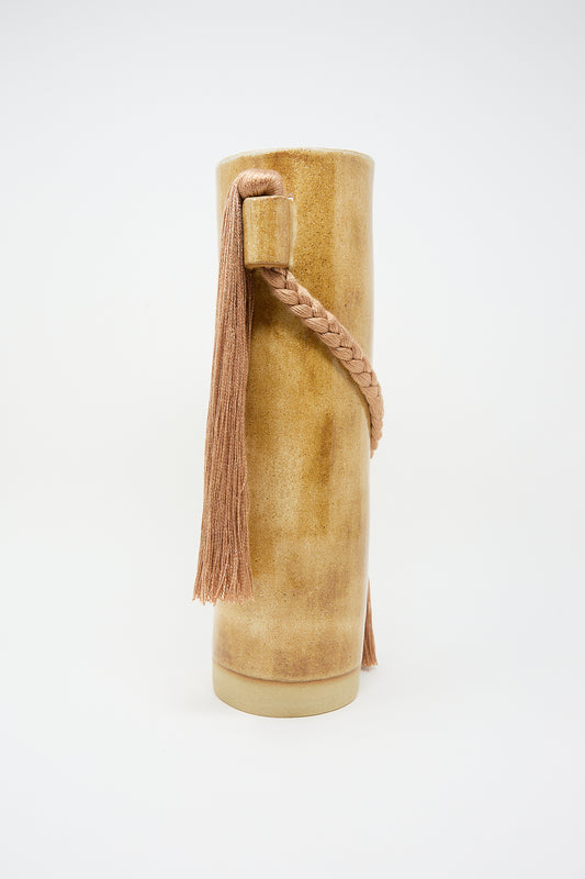 Handcrafted Karen Tinney tan suede boot with tassel detail against a white background.