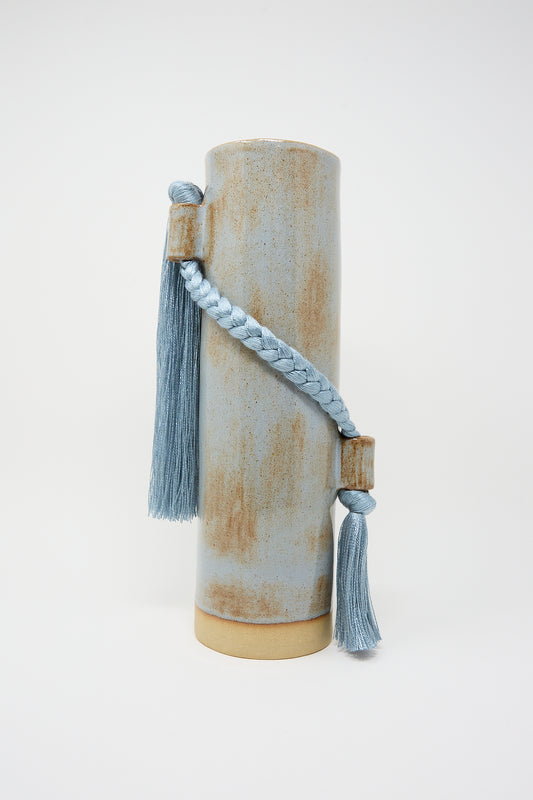 Karen Tinney's Vase #695 in Blue with a rustic finish and a blue tassel decoration, crafted from stoneware.