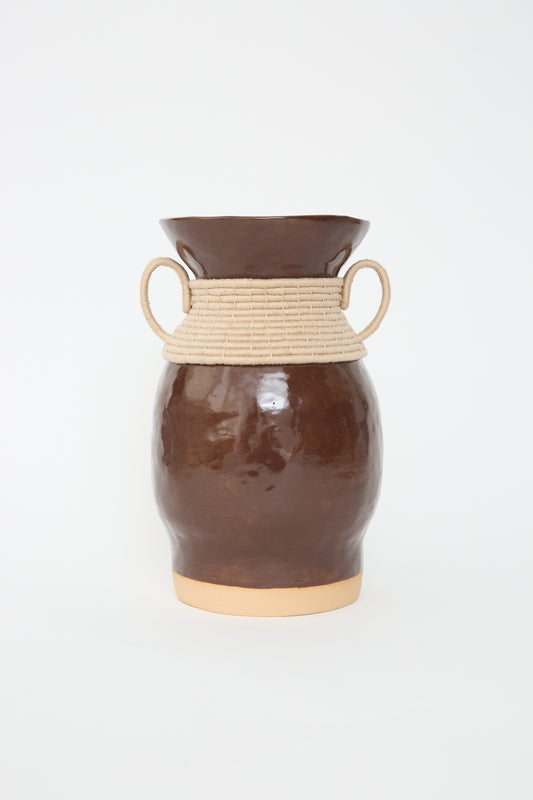 A Vase #808 in Brown and Tan by Karen Tinney with a woven collar and two handles against a white background.